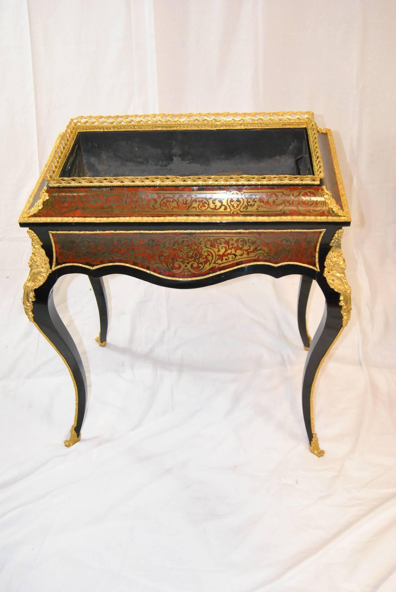 An elegant pair of Bronze mounted Louis XVI French Planters. The black lacquer planters have beautiful bronze mounts and boulle style marquetry with a brass gallery. The scalloped apron combines perfectly with the graceful cabriole legs. There is a