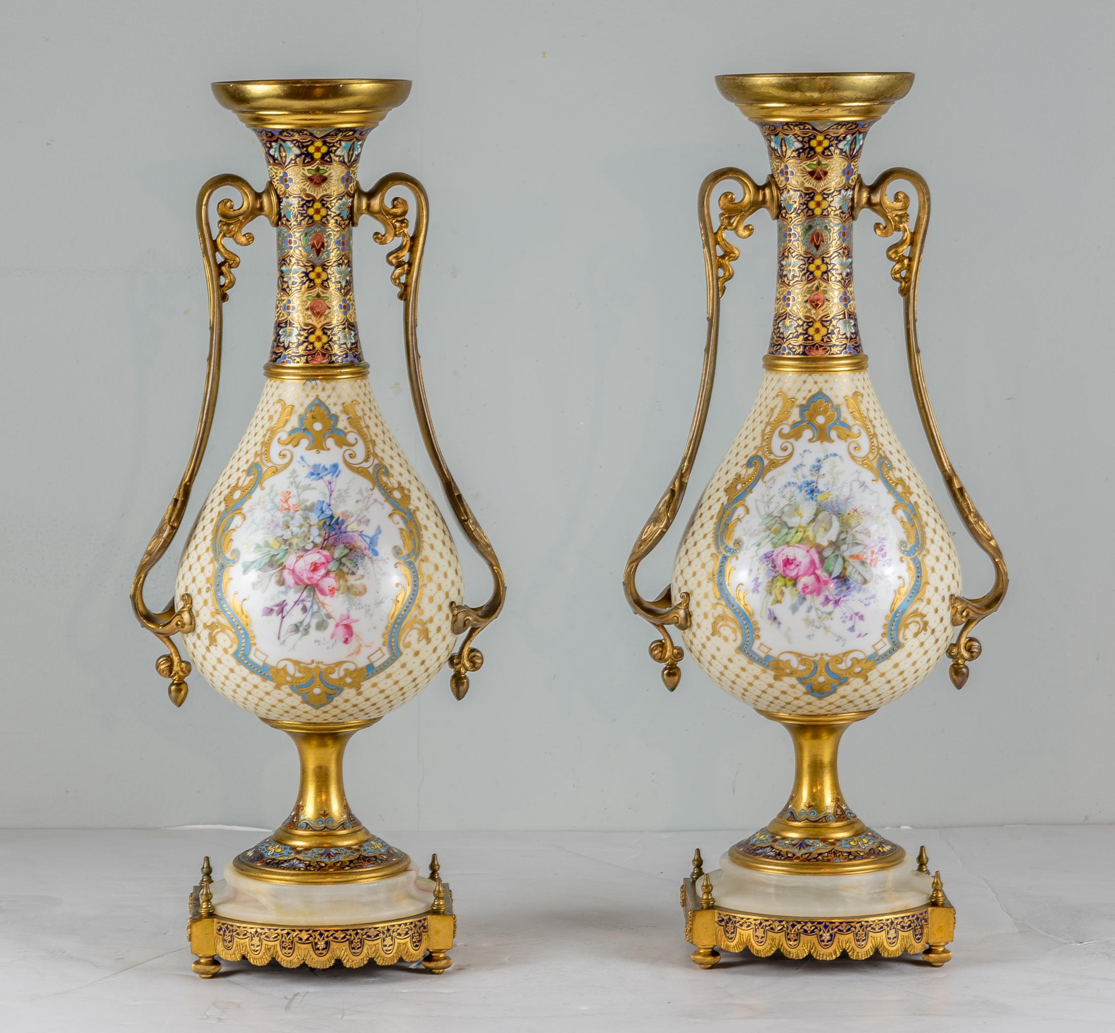 Pair of fine quality bronze-mounted Sèvres style porcelain champlevé enamel vases. The hand painted medallions depicting cherubs and floral motifs surrounded by raised gilt enamel. The porcelain body is mounted to a champlevé enamel and gilt bronze