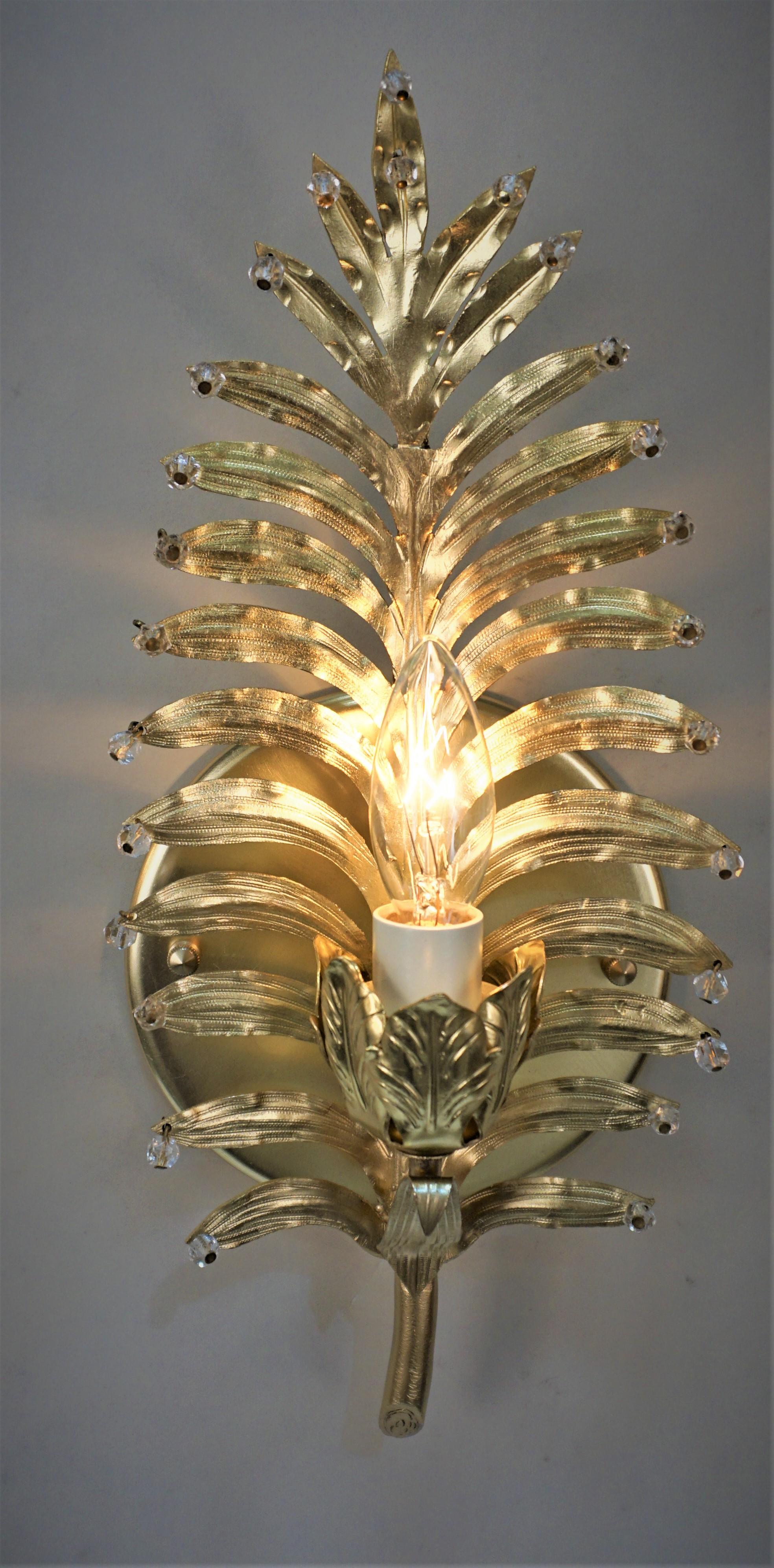 Pair of bronze palm tree leaf wall sconces with round faceted crystals. 
One light 75watts max.
New wiring and ready for installation.
