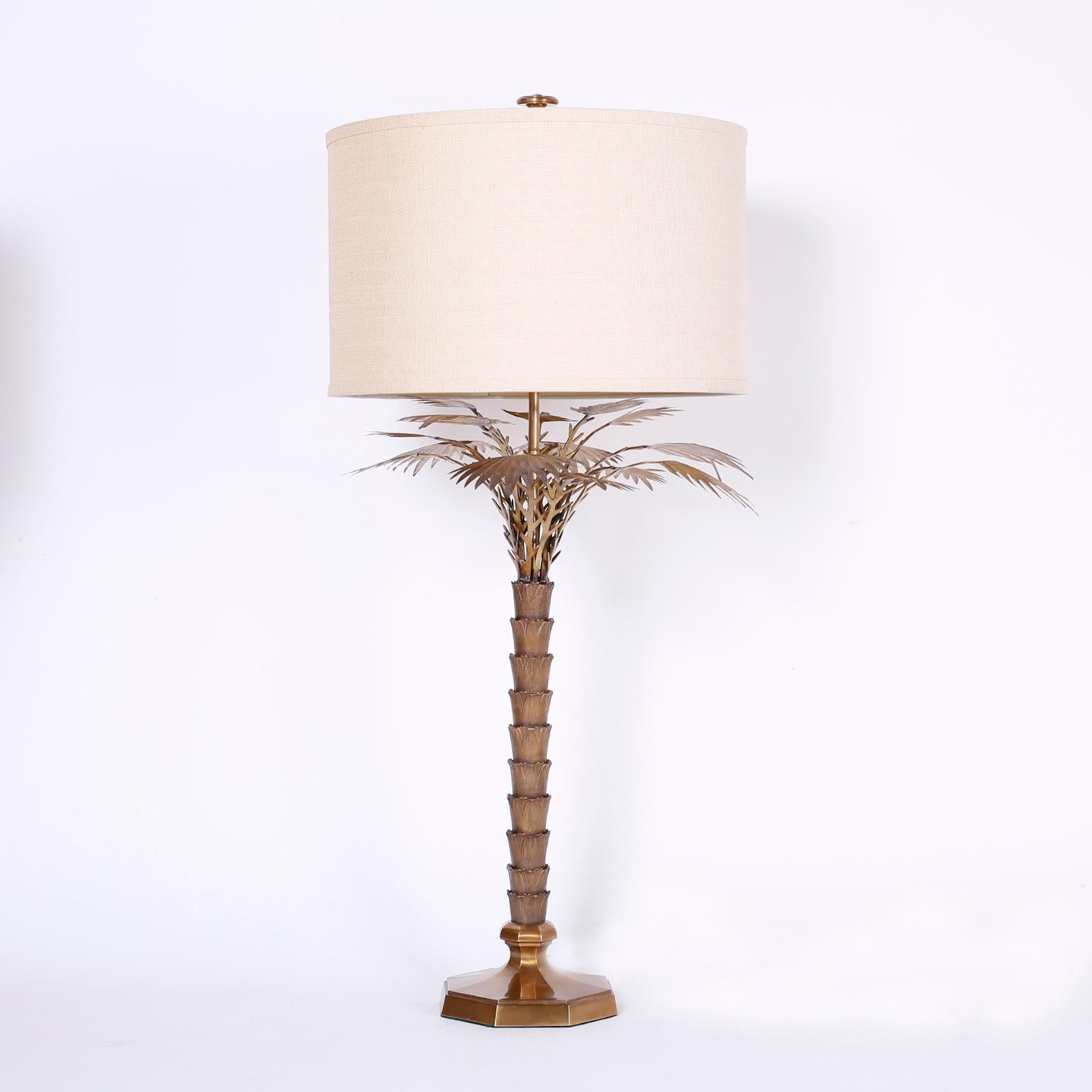 Chic pair of stylized palm tree table lamps crafted in bronze having a custom acid washed finish and lacquered for easy care.