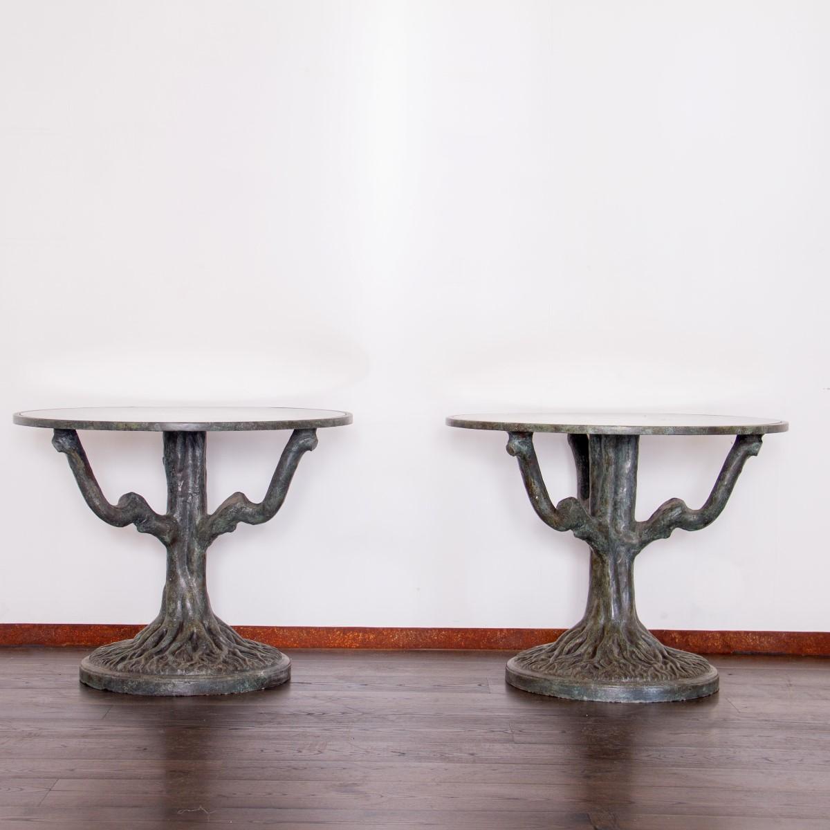 A stunning pair of 1960s romantic  side tables on whimsical sculptural tree trunk bases complete with detailed roots, finished in a green bronze patina. The circular tops have antique mirror inset tops.

These tables are large and can be used as