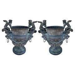 Pair of Bronze Planters with Cherubs and Lion Faces with Rings