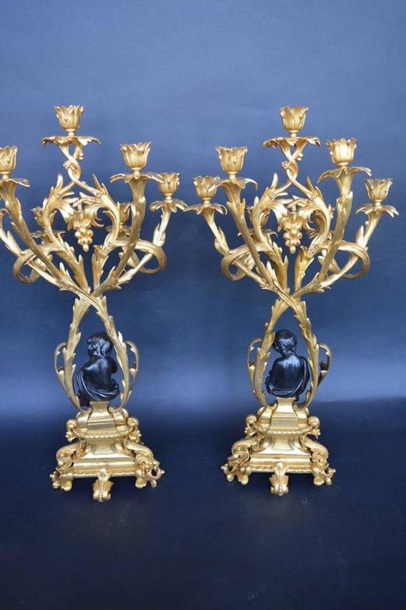Pair of bronze putti candelabras.
