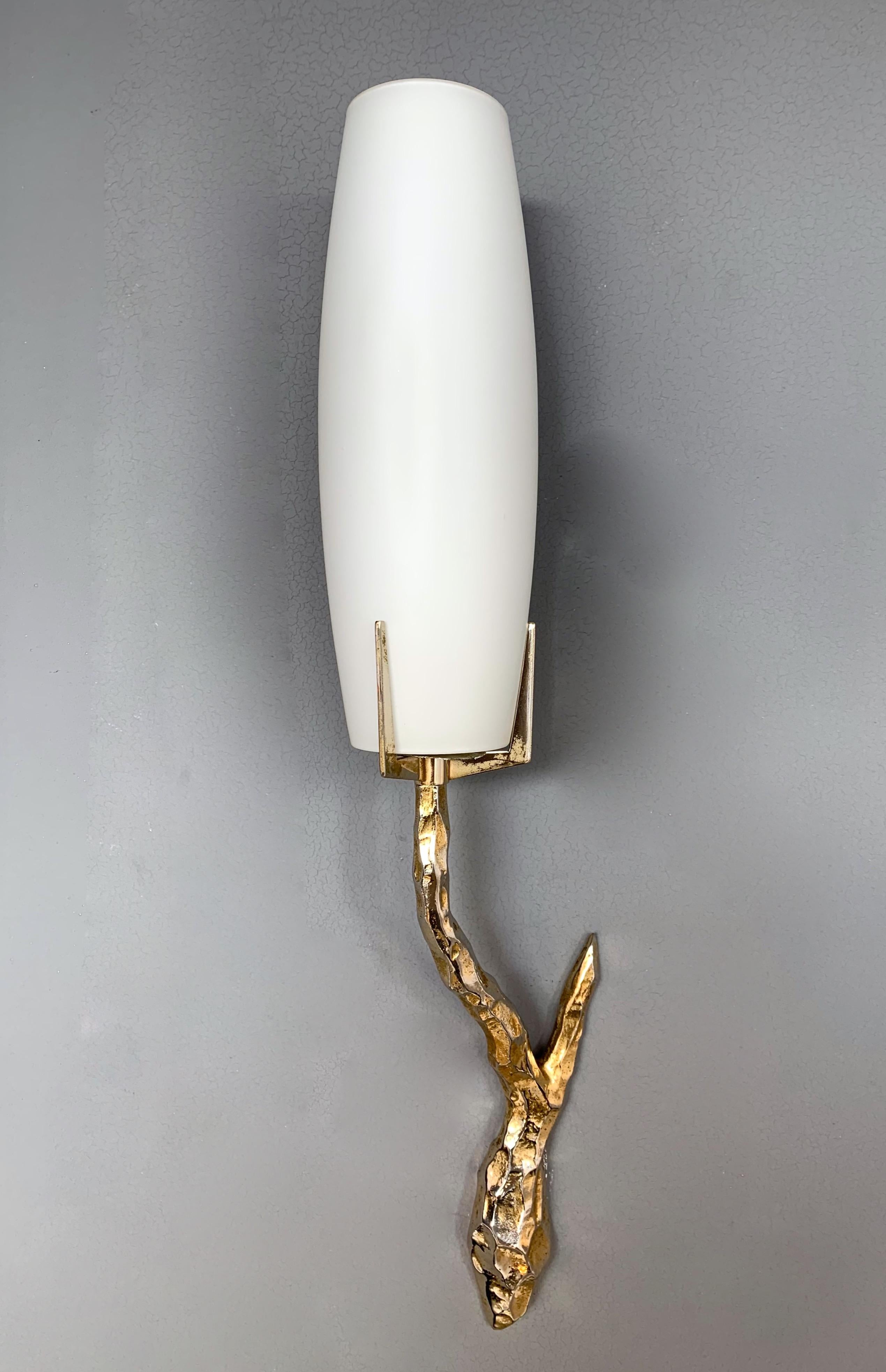 Pair of wall lights sconces cast gilt bronze and opaline glass diffusor by Maison Arlus, very interesting and sculptural model based on Felix Agostini drawing for the manufacture. On request original Arlus advertising from the 1960s. It’s a famous