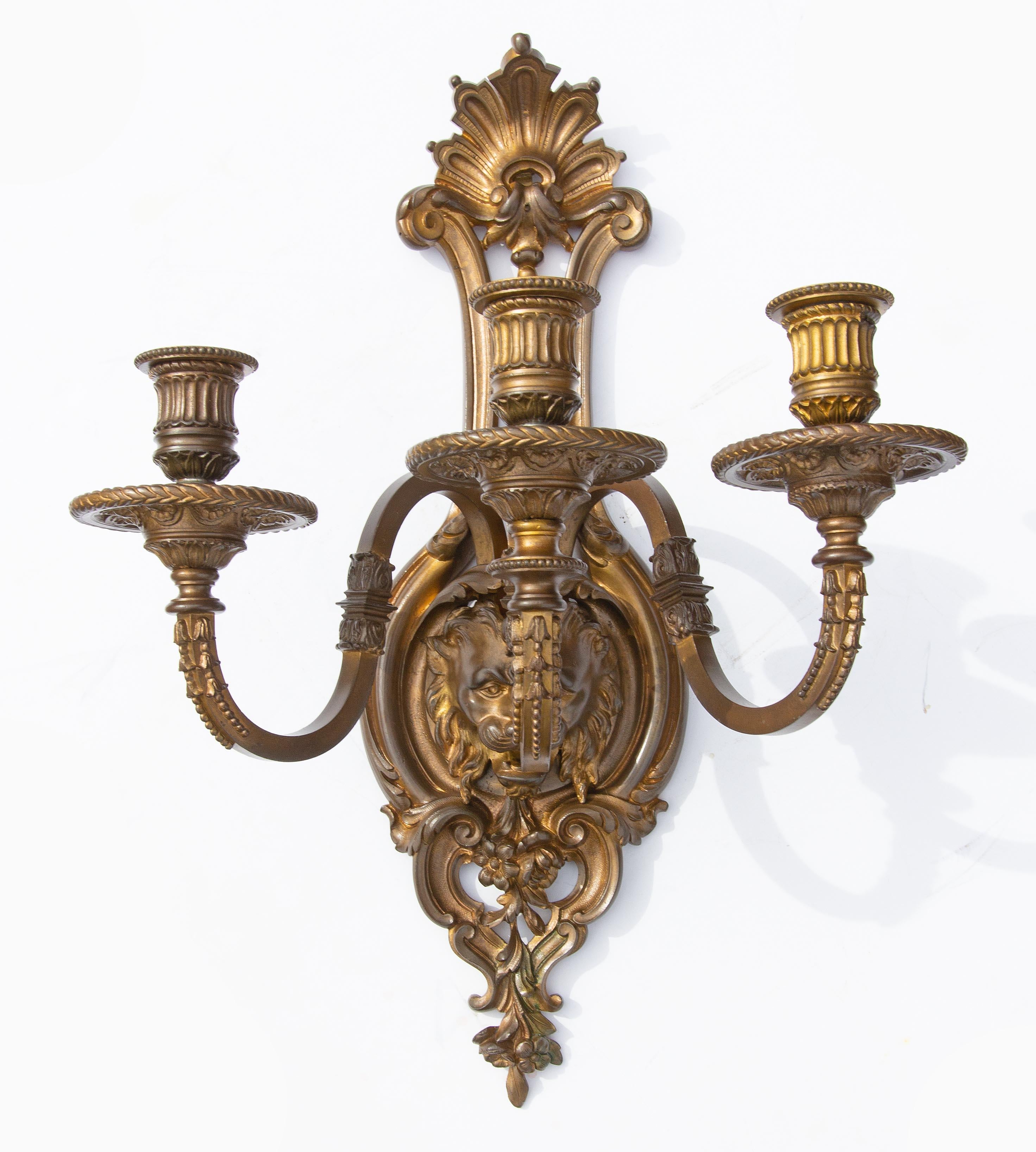 Pair of Renaissance Revival bronze sconces with lion faces, early 20th century.