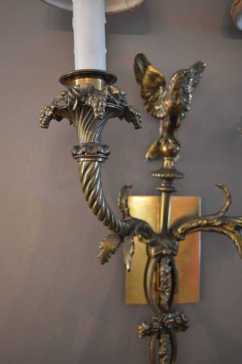 Pair of bronze sconces with shades.