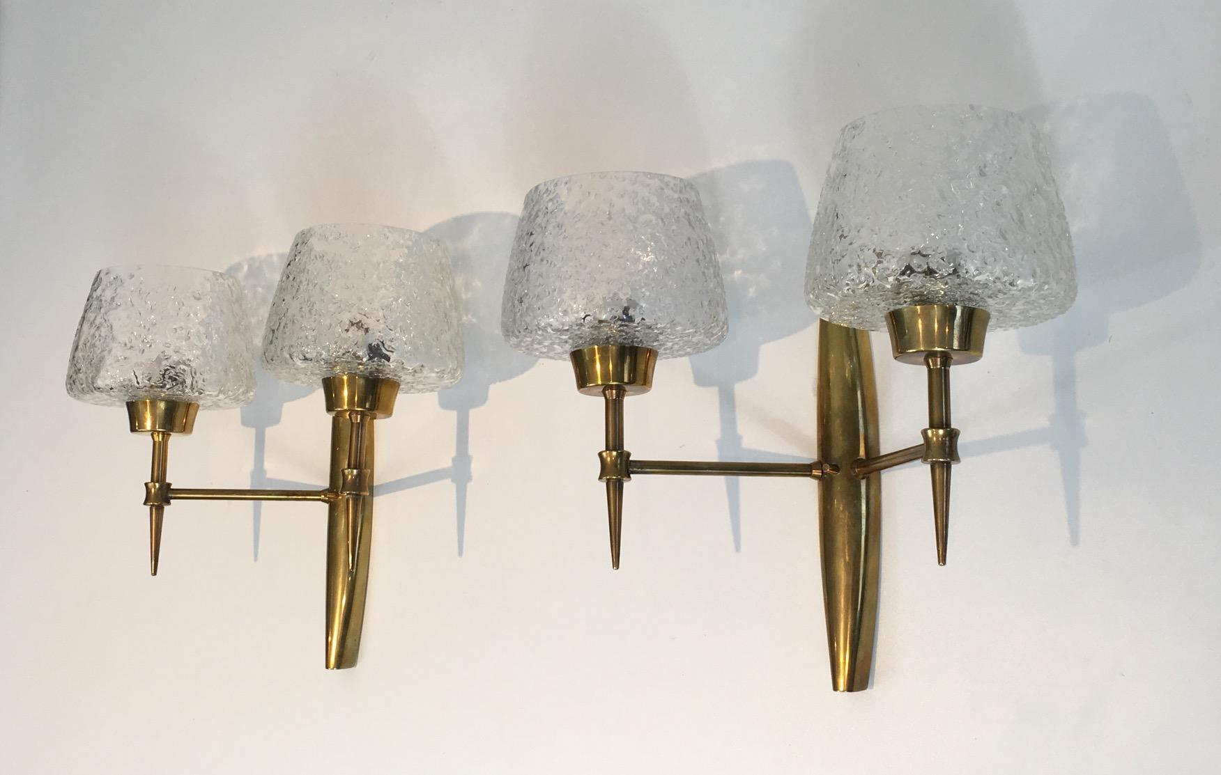 This rare and fine pair of mid-modern wall lights is made of bronze with beautiful worked glass reflectors. The quality of these sconces is really good. They are Italian in the style of Stilnovo. Circa 1960