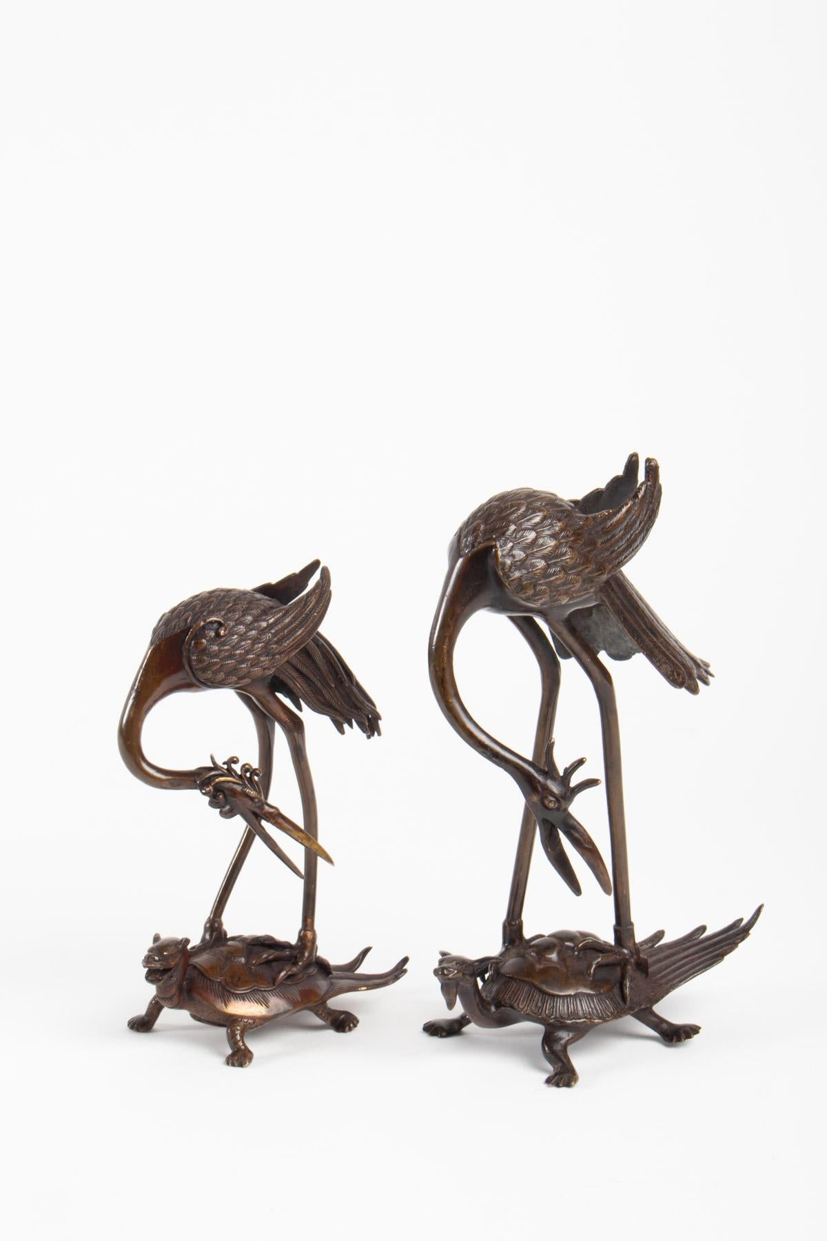 Pair of bronze sculptures, Japan, late 19th century representing a heron on a turtle.
Large: H 23cm, W 18cm, W 10cm
Small: H 18cm, W 12cm, W 8cm.