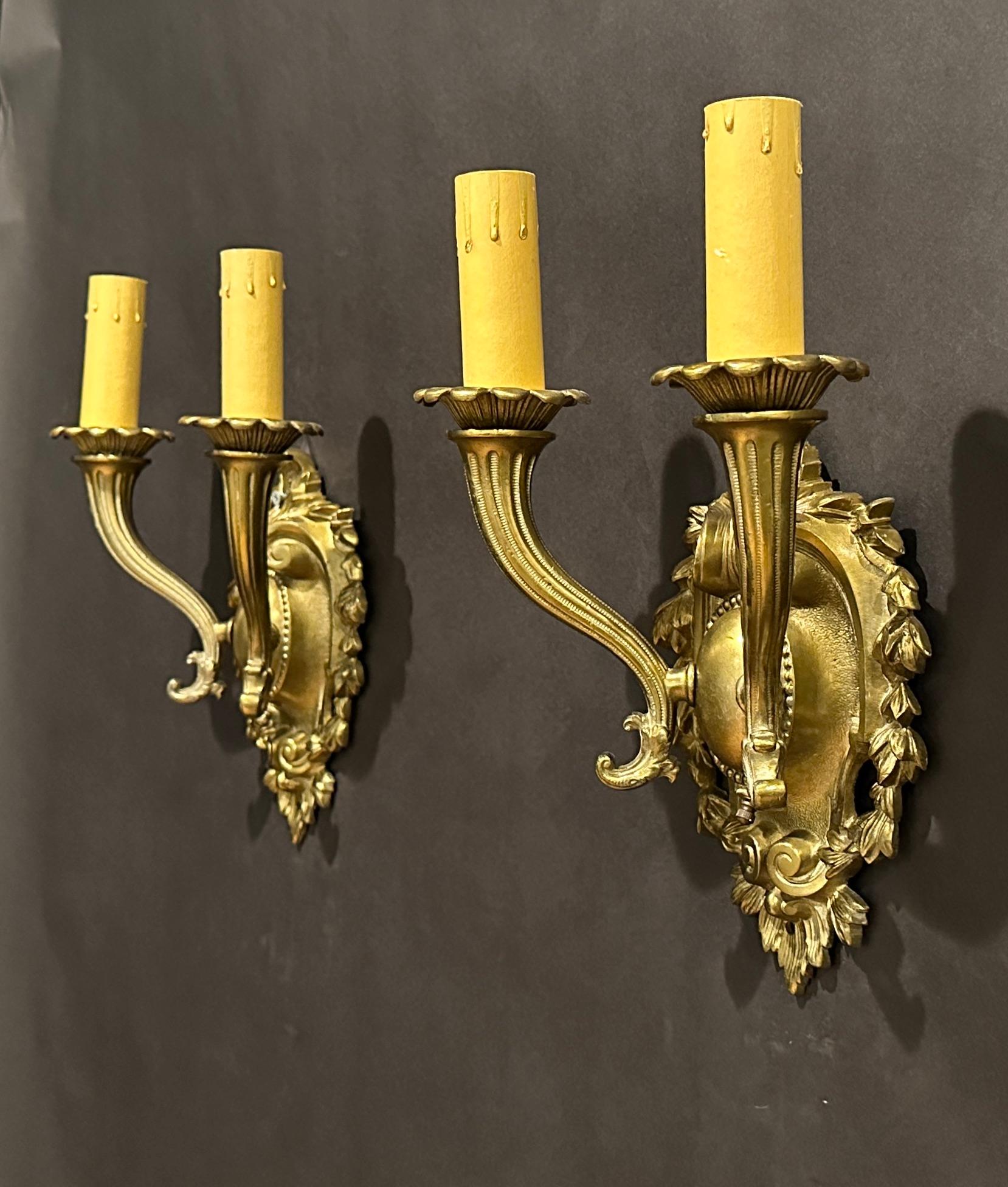 Pair Of Bronze Shield Back Two Arm Wall Sconces In Good Condition For Sale In Norwood, NJ