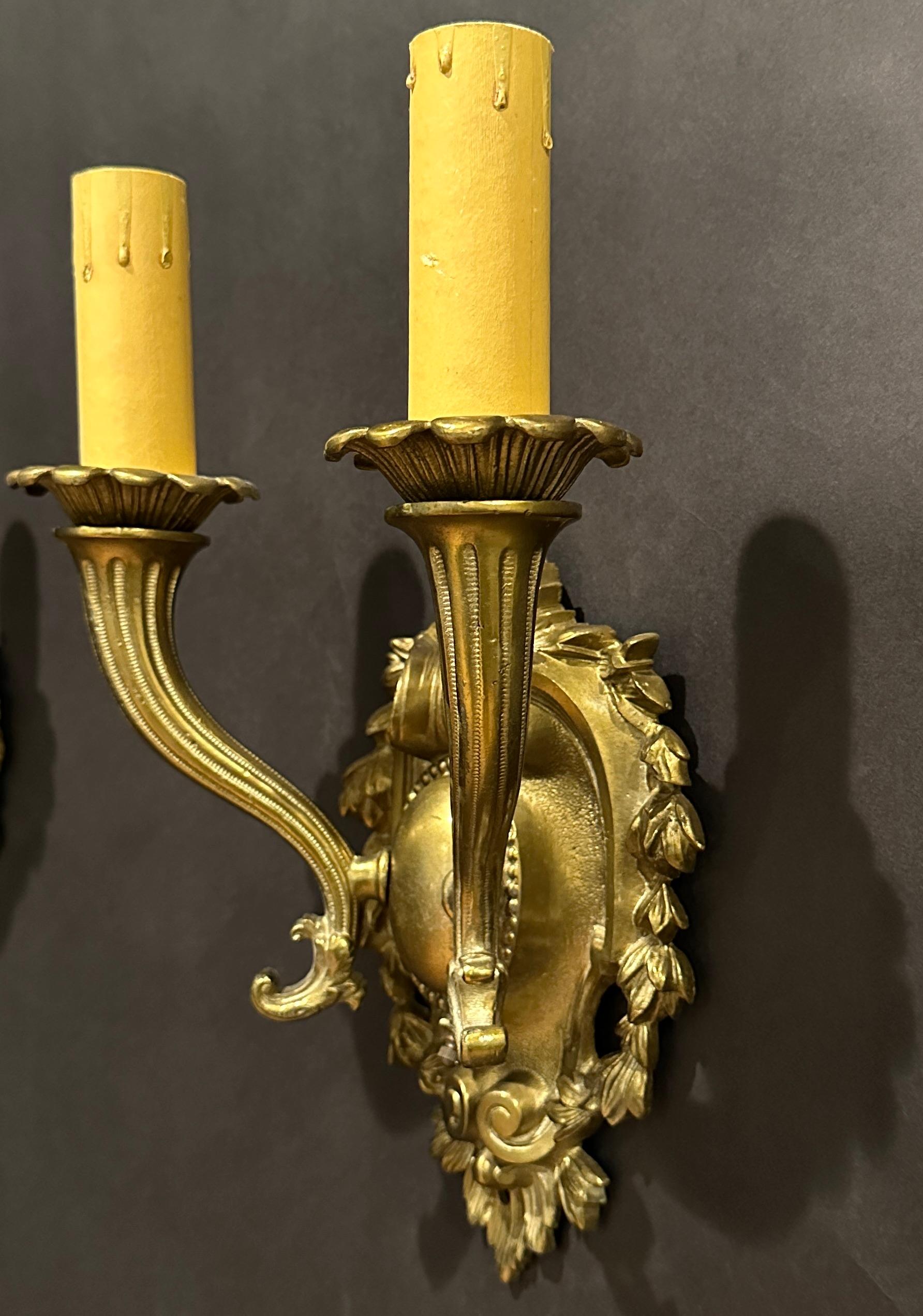 20th Century Pair Of Bronze Shield Back Two Arm Wall Sconces For Sale