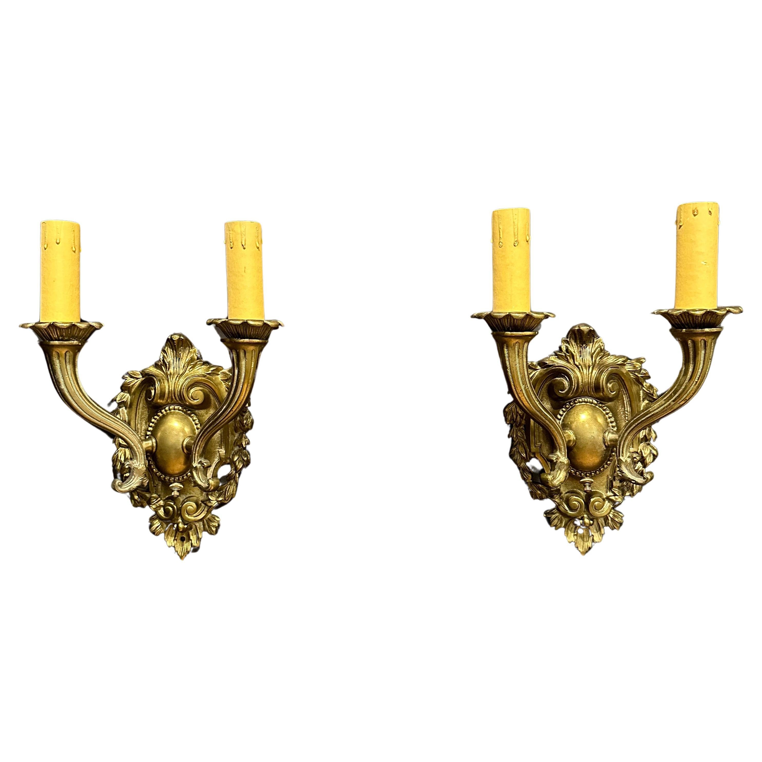 Pair Of Bronze Shield Back Two Arm Wall Sconces For Sale