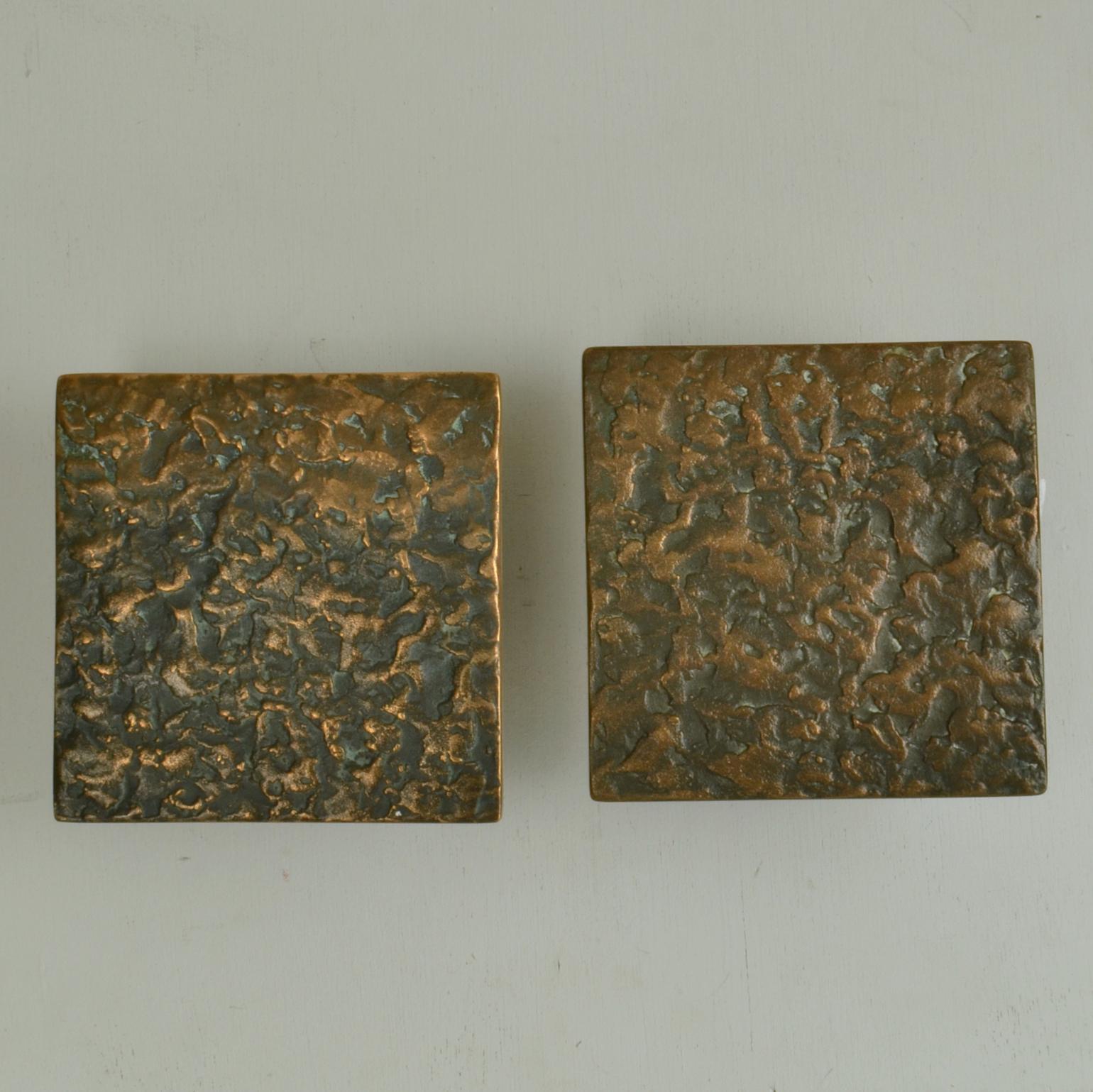 Set of two square Brutalist bronze door handles with relief a subtle relief and texture with original patina, European 1970's. 
These identical handles can be applied inside or outside on a pair of double doors next to each other or on a single door