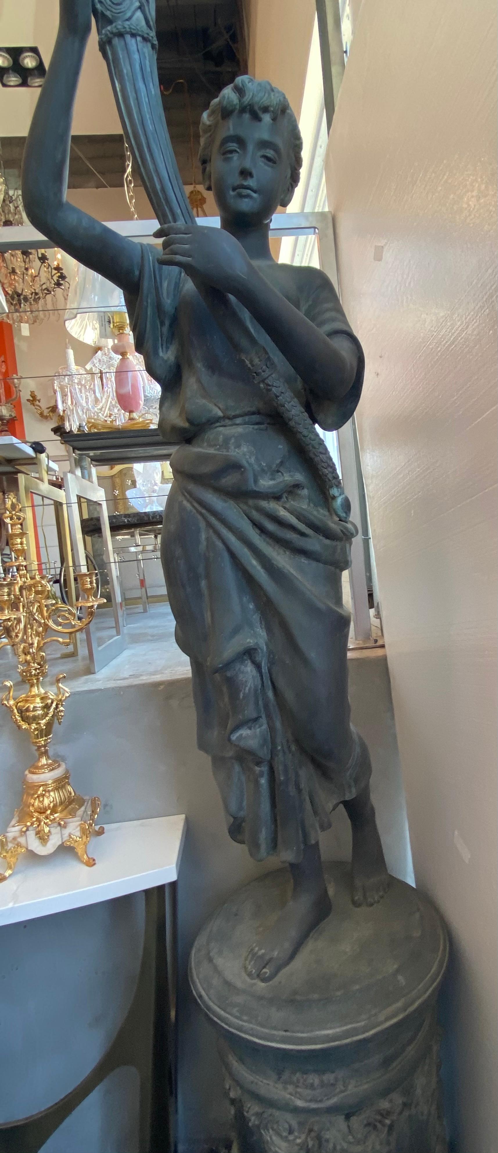 Large pair of bronze lady with torch, this bronze statue is perfect for an outdoor entry since they are large, and come with a working torch lantern.