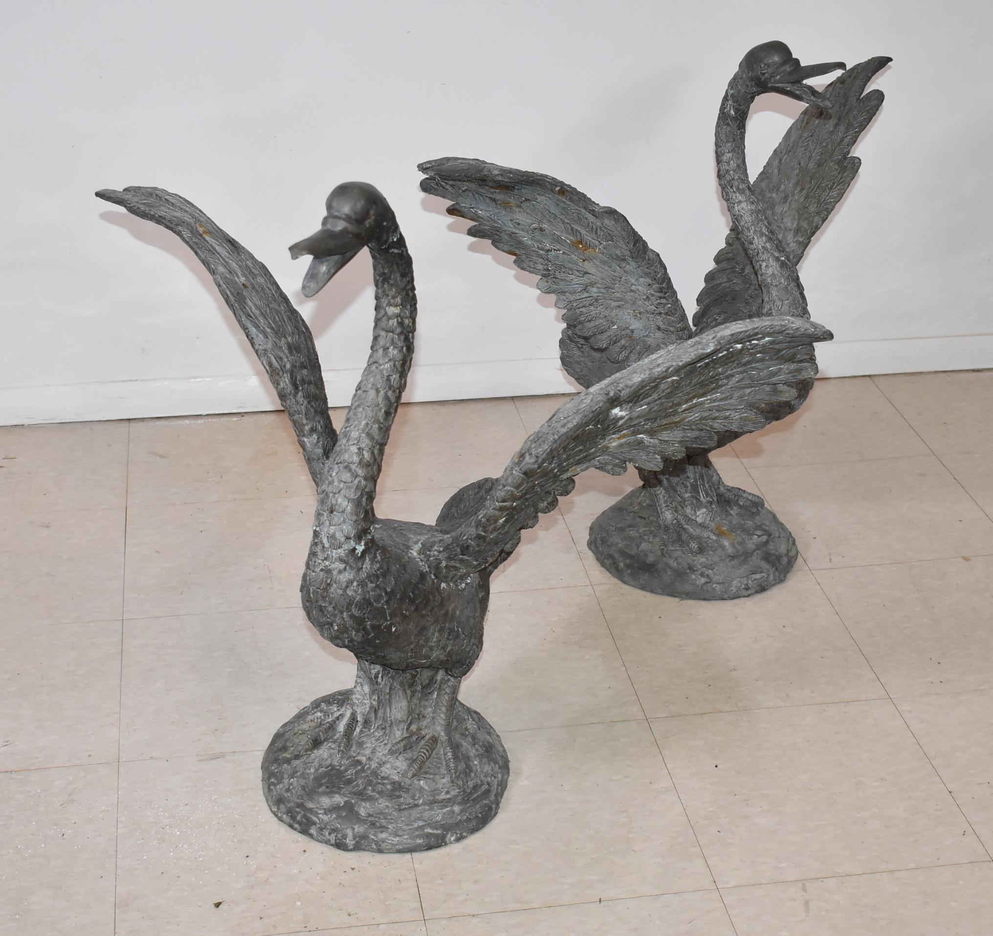 Fantastic pair of bronze swans fitted with copper tubing for a garden fountain. Circa 1920's. Great lifelike detail. Each measures 33
