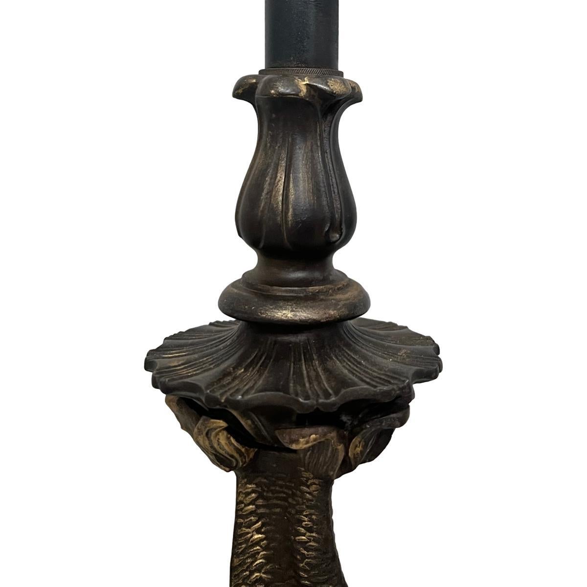 Pair of circa 1920's French patinated bronze table lamps shaped as 3 intertwined stylised dolphins.

Measurements:
Height of body: 22