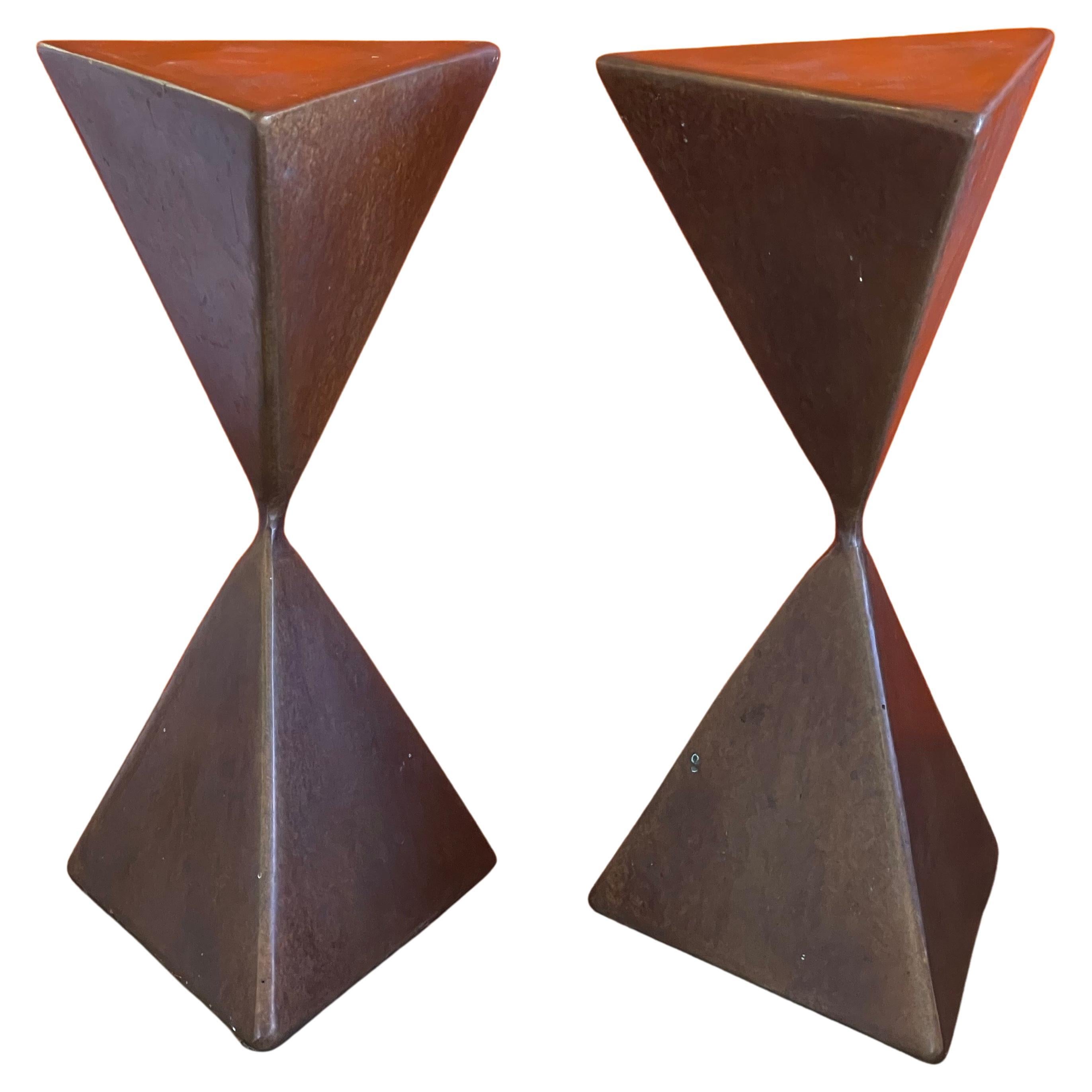 A super cool pair of bronze triangular totem pedestals by Rod Kagan circa 2007. The set can be used as small display pedestals or as decorative art sculptures.  They are in very good condition with a great patina and superbly balanced; each piece