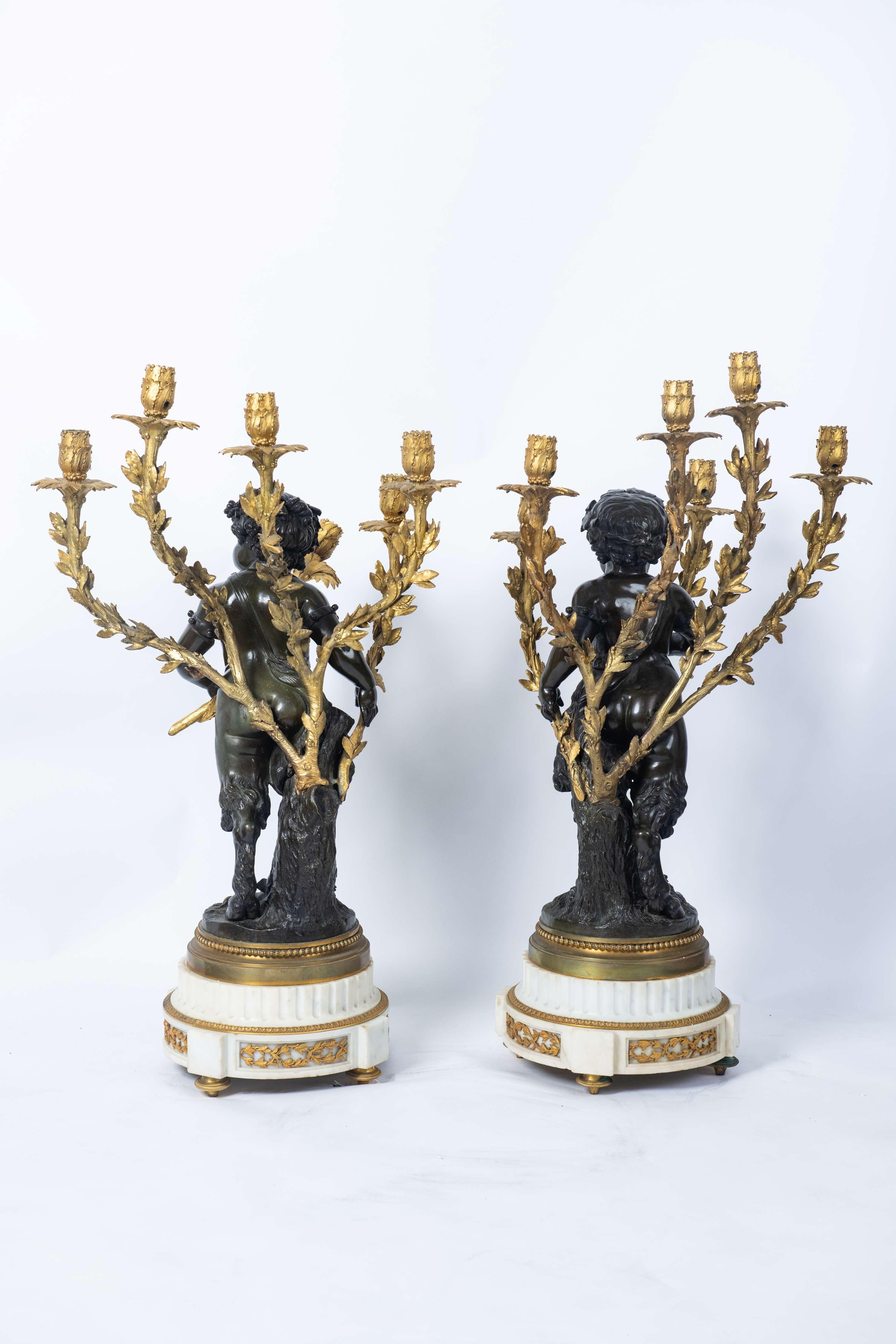 Pair of ormolu and patinated bronze twelve lights candelabra
The figure after the model by Claude Michel dit Clodion et Louis-Felix De La Rue
French circa 1820
H: 80 cm

Provenance: French private collection
The figures of these candelabra were