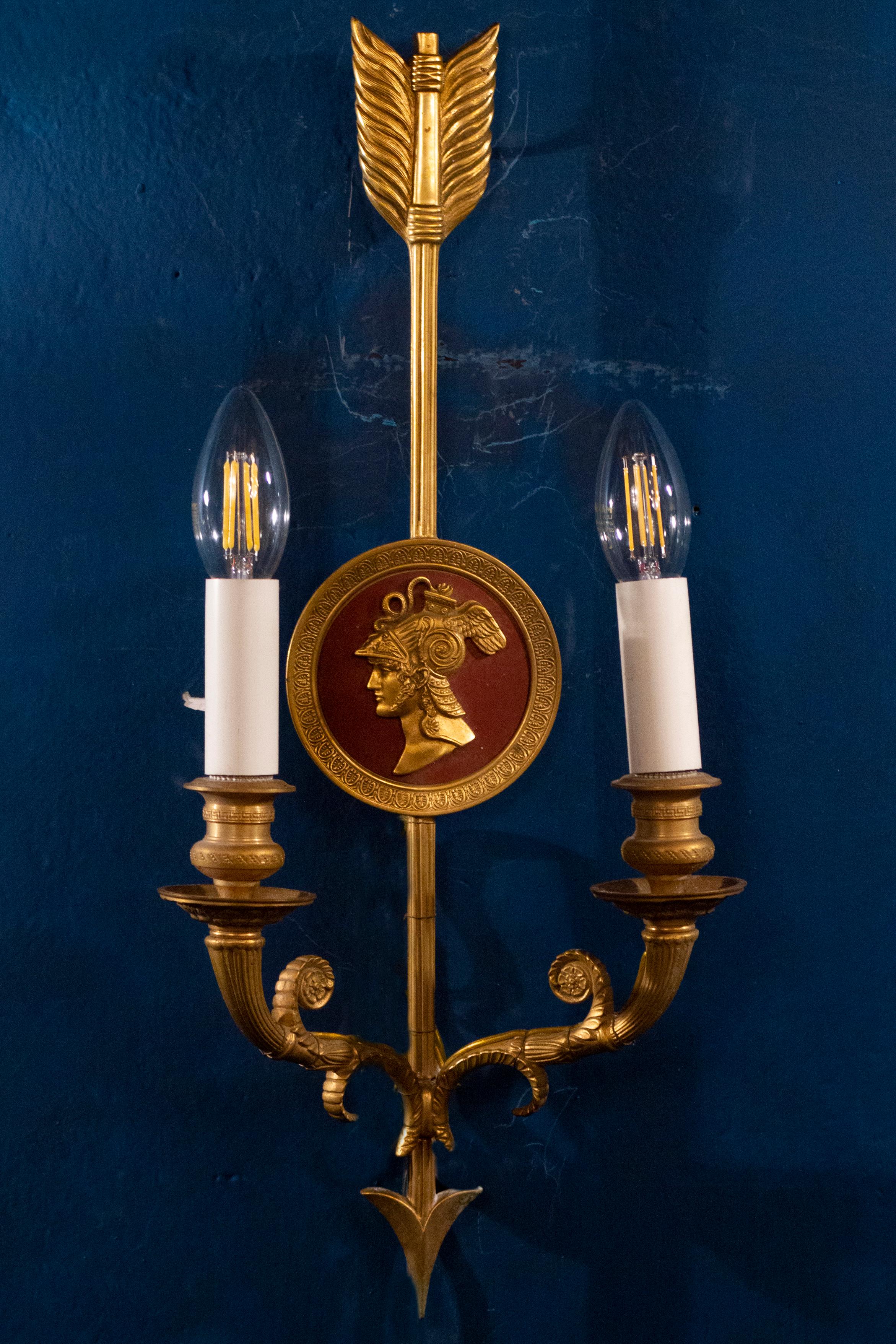 A pair of bronze two-light neoclassical wall sconces.
Available an other pair with a blu centered decoration.
Measurements: 48 x 22 cm.