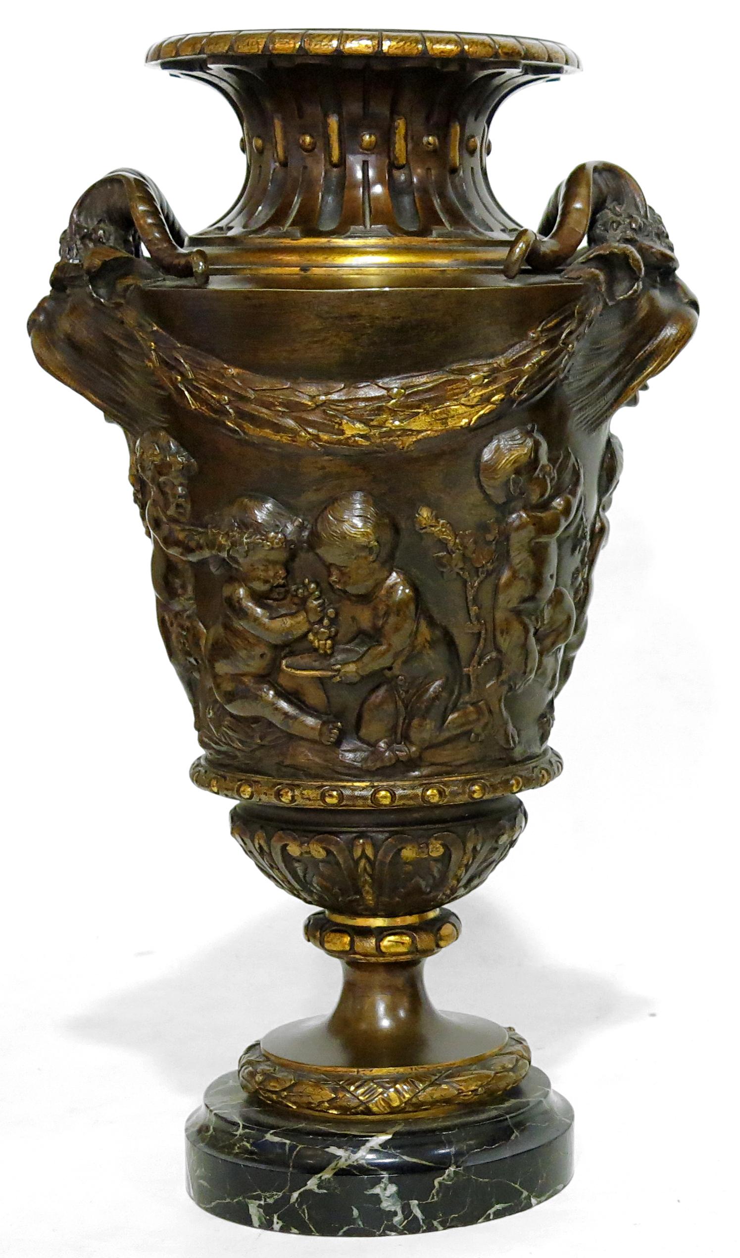 Fine pair of bronze vases, well chiselled, with a gilt and brown patina in the Louis XVI style. Ovoid shape, with circular decoration of a freize with Cherubs, pampres, and leafy flowered branches. Wide-mouthed flute neck, handles represented as