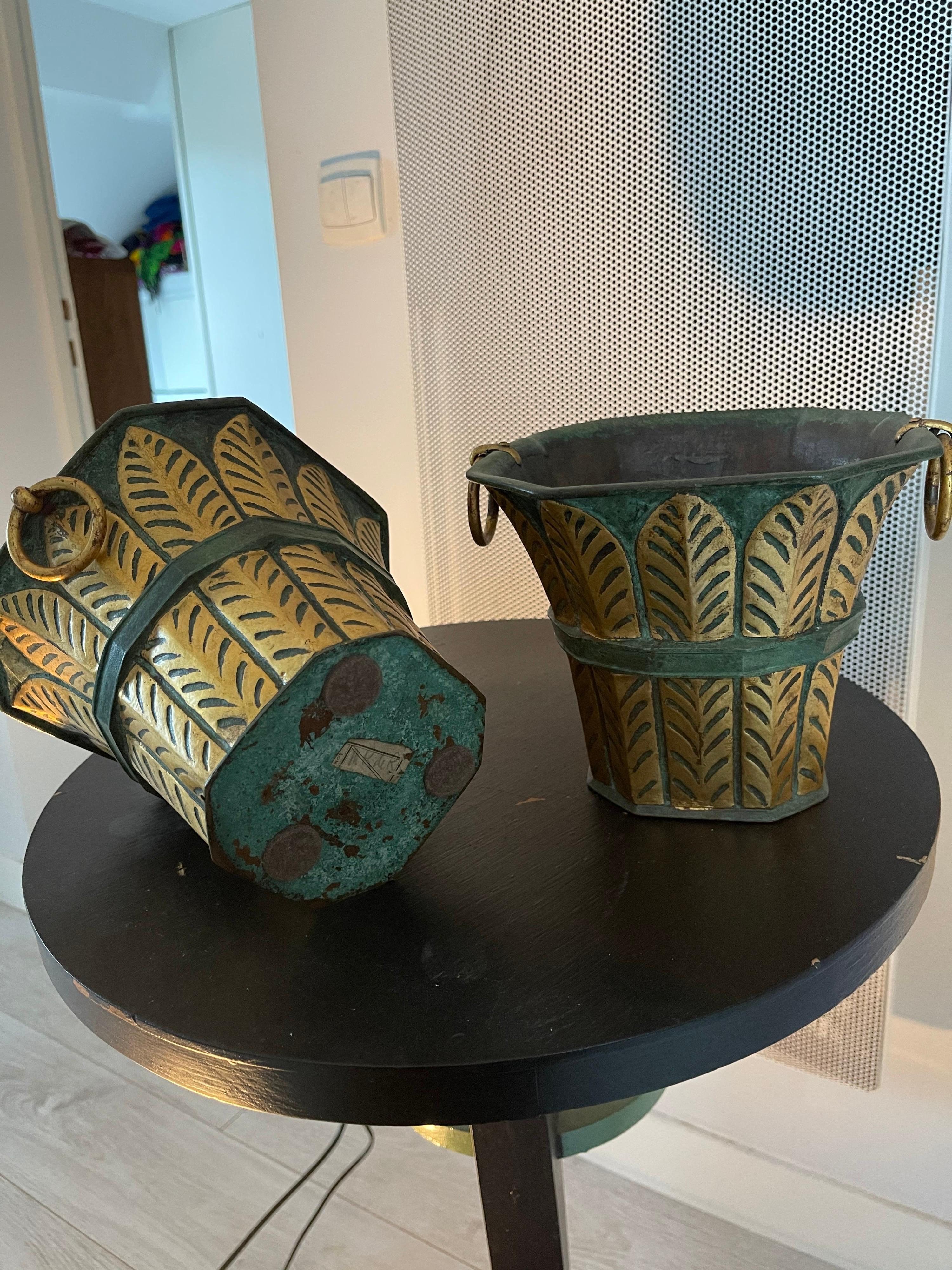 Pair of bronze decorative vases early century painted green and gold leaves
attributed to Dunand.