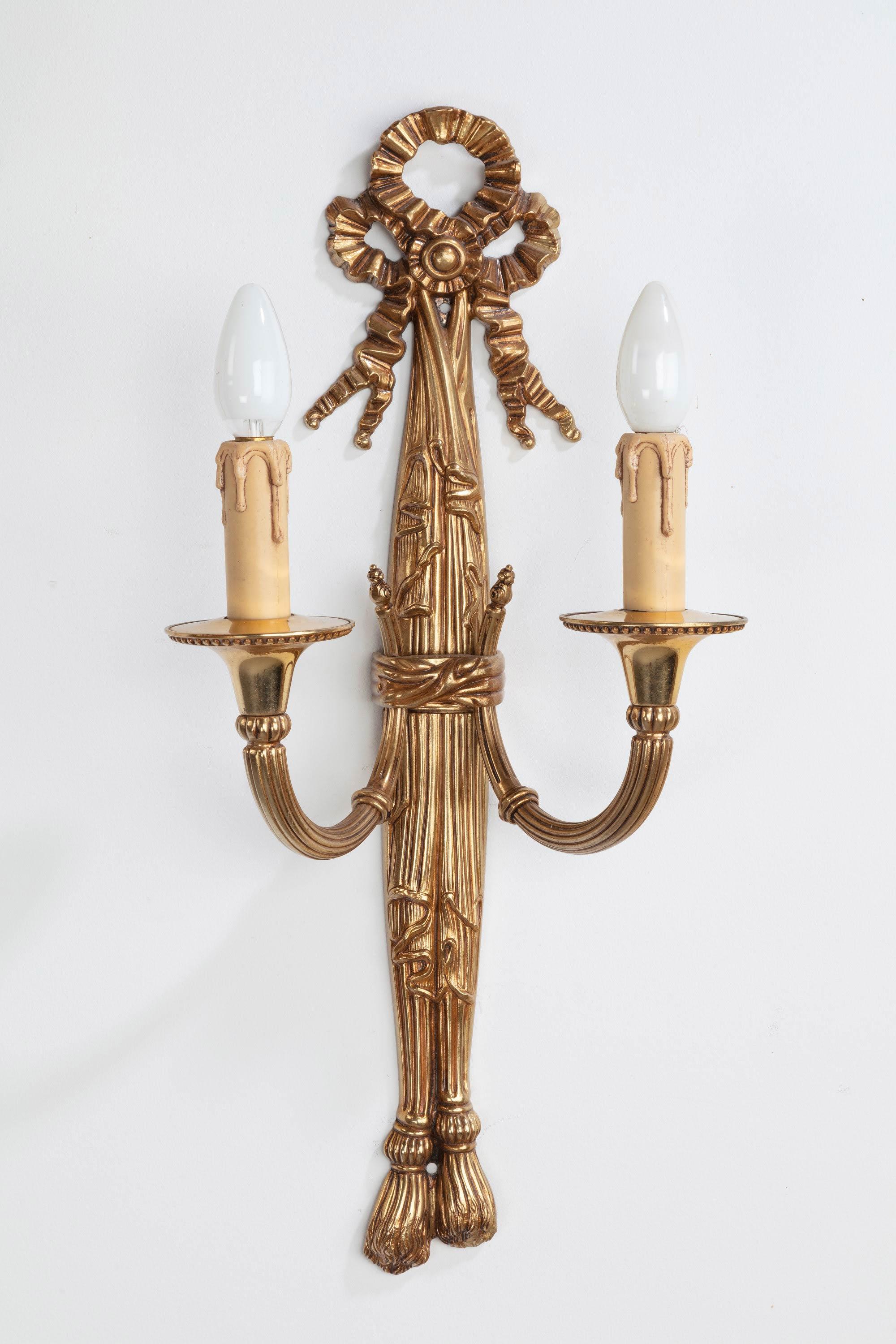 A pair of gilt bronze wall lights in the manner of Robert Adam. The tops with fronds and the overall central stem in the manner of pleated and folded fabric. Very good quality.
 