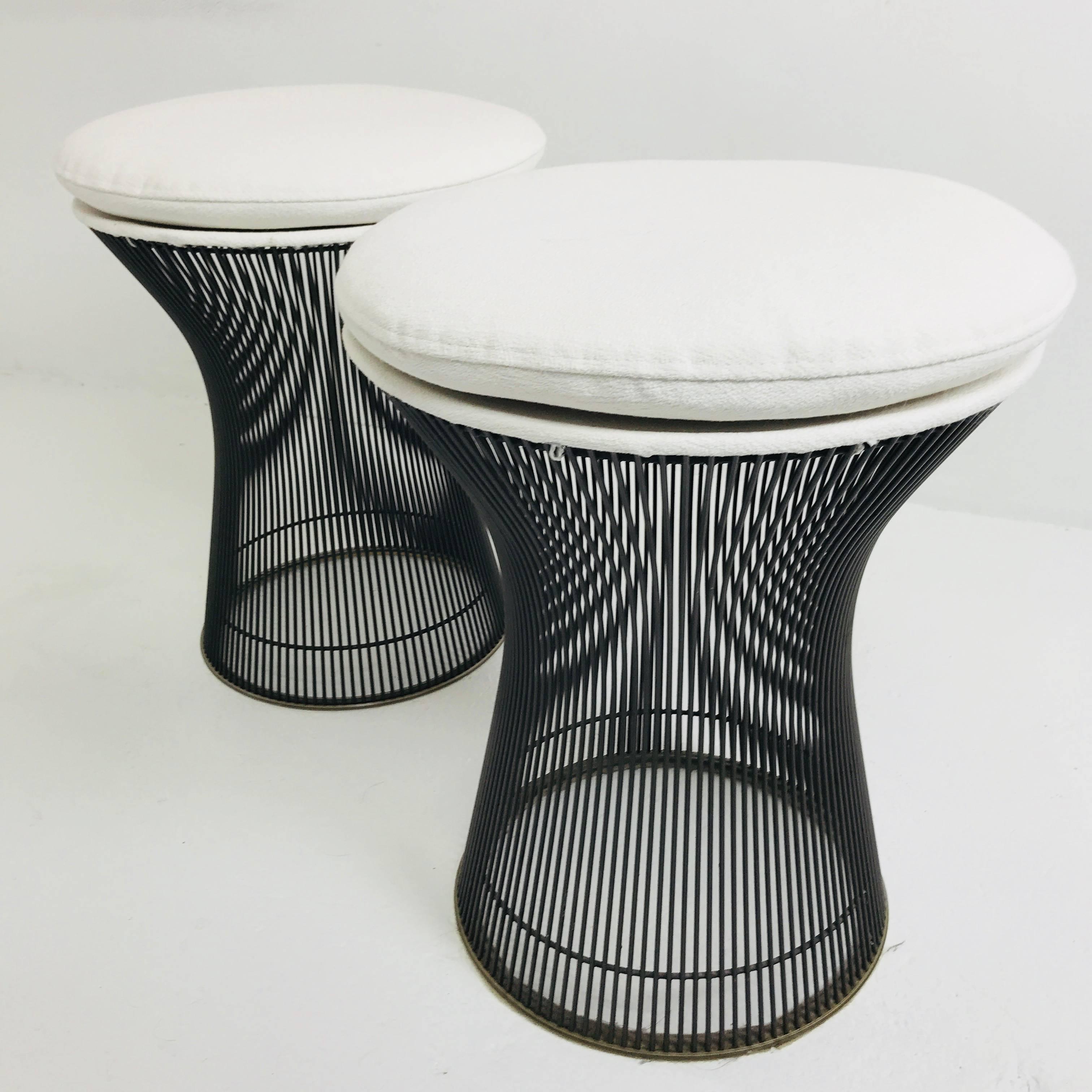 Pair of newly upholstered bronze Warren Platner stools. This iconic design features bronze wire rods with a clear coat finish and clear plastic resin on the bottoms of the bases to protect floors. The bronze is in excellent