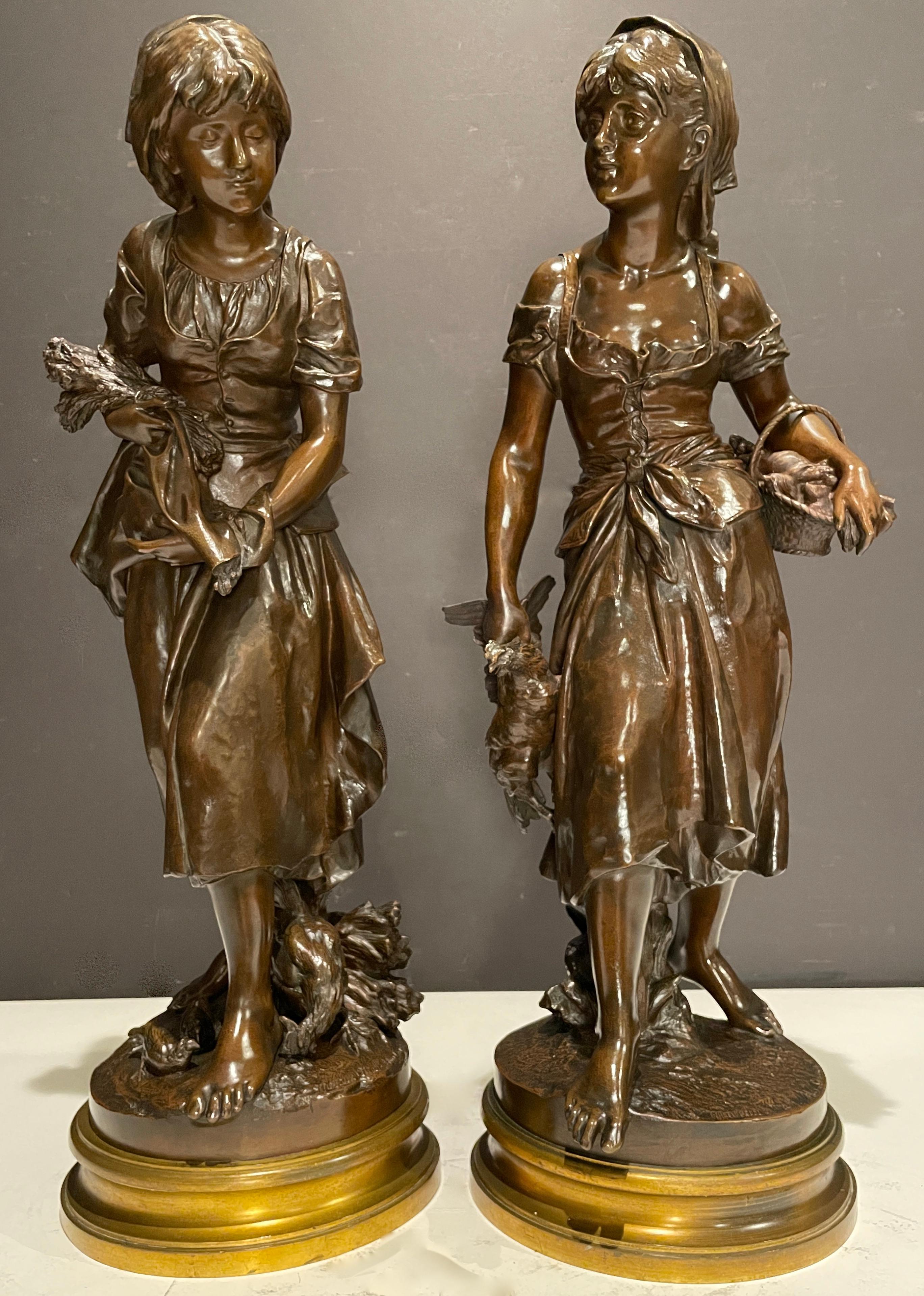 Mathurin Moreau (1822 - 1912) France. Large pair of bronzes in opposition with rich brown patina. Original 19th century bronze sculptures of Two young girls in a field with chickens and baskets. Fine quality and beautiful image. Each signed at base,