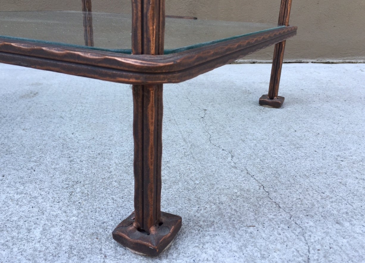 Pair of bronzed iron, two-tiered side tables by Claudio Rayes. Clear glass tops. Labeled.
