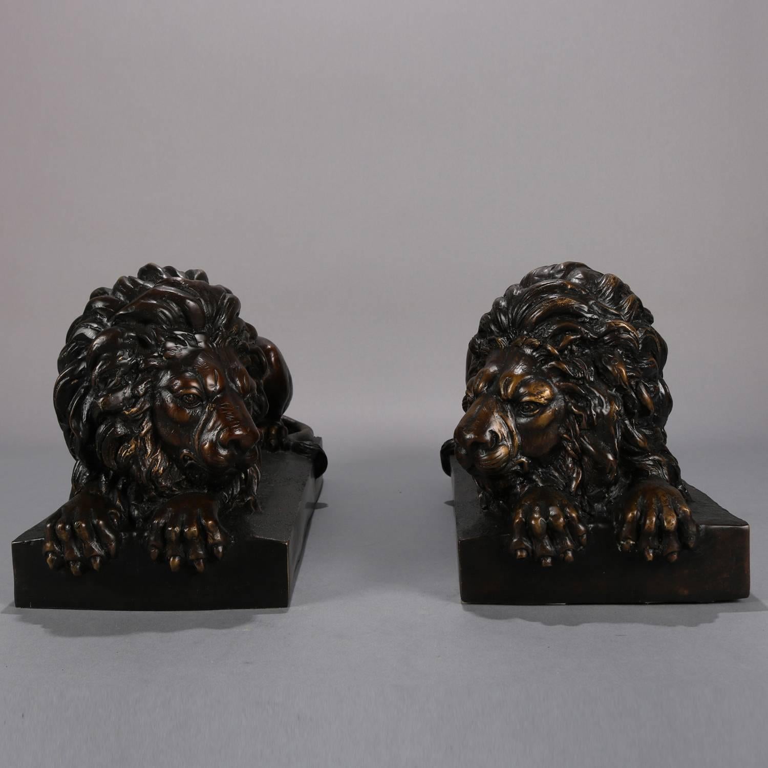 Pair of finely detailed bronzed cast metal sculptures of resting recumbent African lions, 20th century

Measure: 9