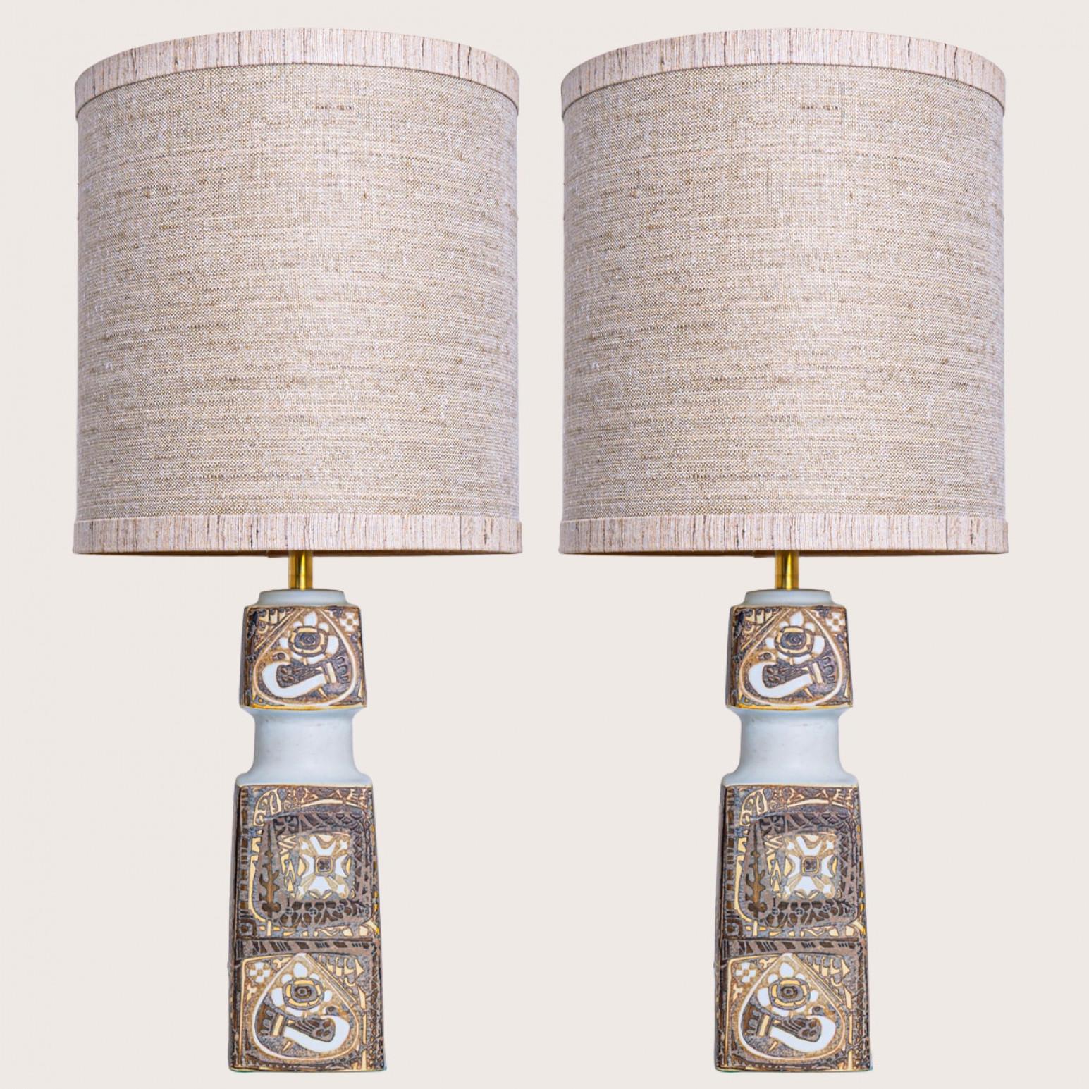 Pair of heavy quality ceramic table, 1960s Denmark. The lampshades are designed by Rene Houben.

This lamp base brings refined elegance and rich visual appeal to any interior. With its beautiful shape and texture, it offers a unique