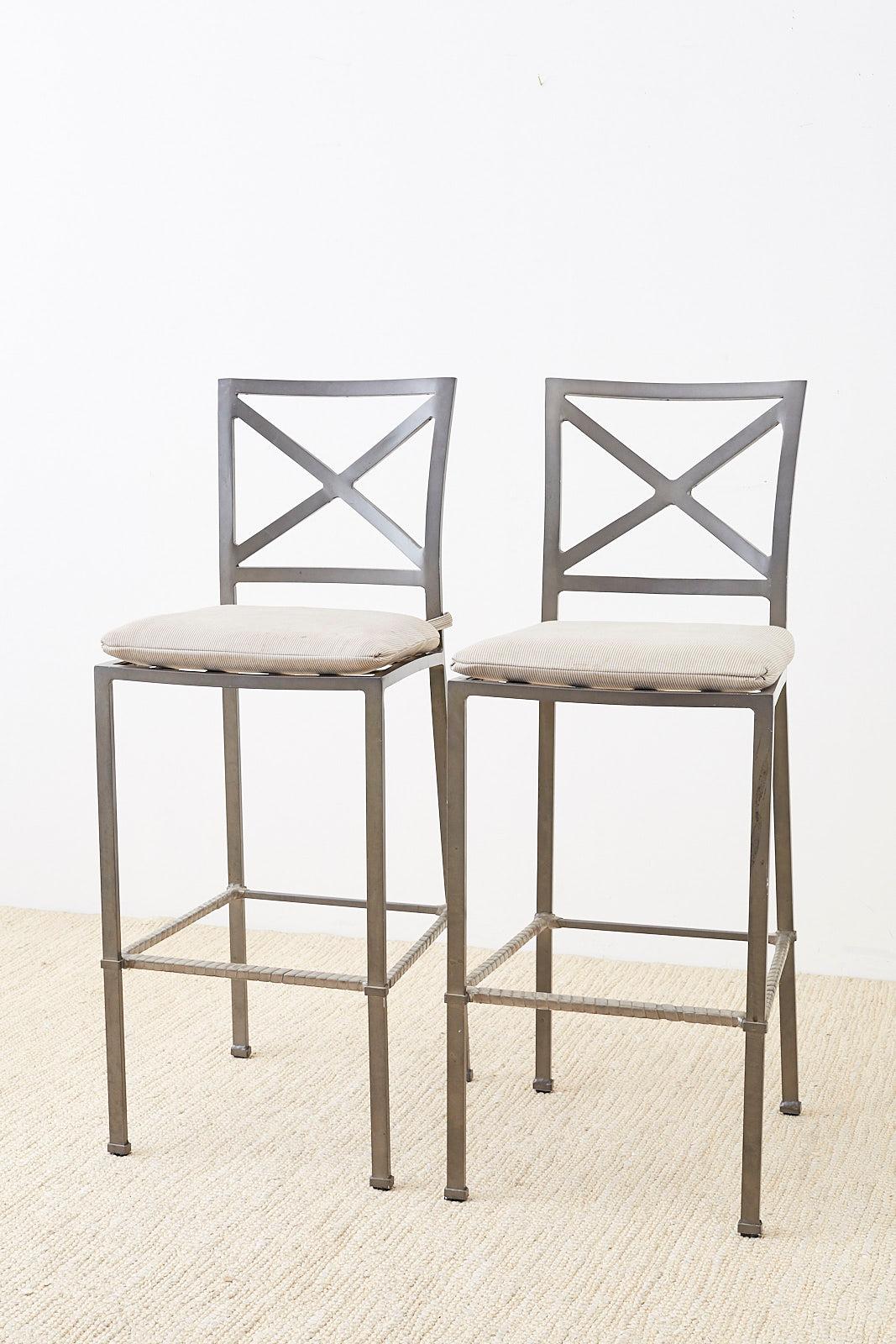Powder-coated pair of patio garden barstools by Brown Jordan. Constructed from aluminum and finished in a grey color. Each chair has an X-motif square back and straight legs with a box stretcher footrest. Designed by Richard Frinier and known as the