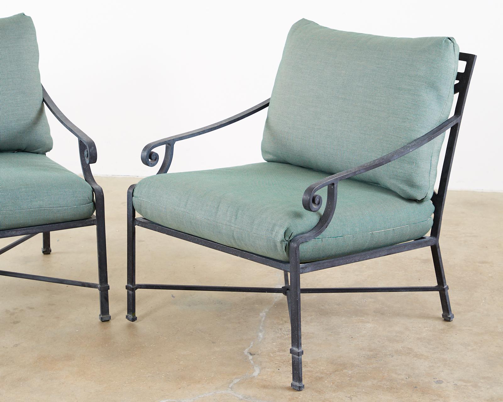 Generous pair of patio and garden lounge chairs made by Brown Jordan. Constructed from wrought aluminum with a multi-step powder-coated finish. The black patina has faint silver and gold flecks on the finish. Known as Brown Jordan's Venetian design.