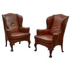Pair of brown leather 1920s wingback chairs