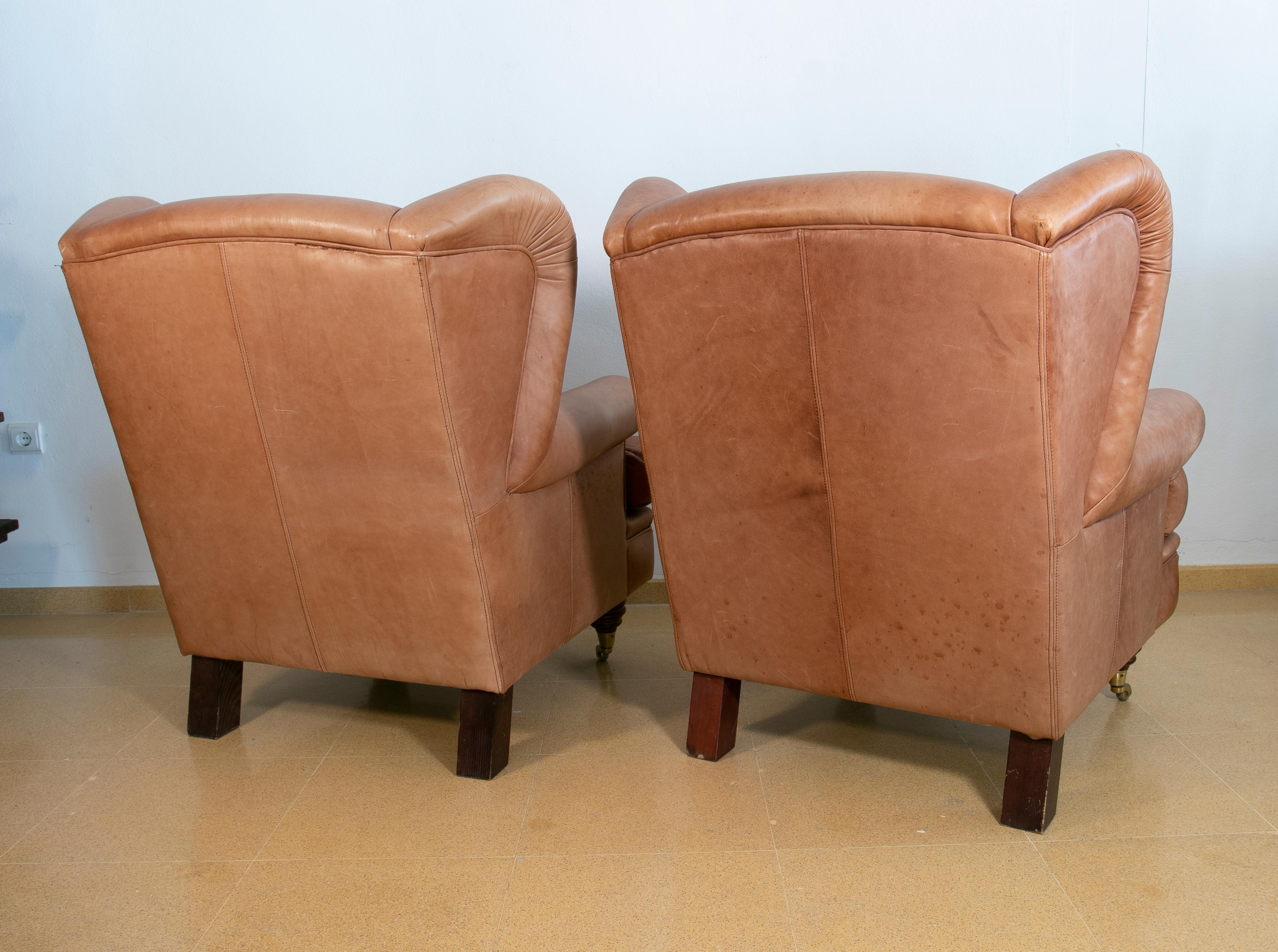Pair of Brown Leather Armchairs with Wooden Legs and Brass Wheels For Sale 2