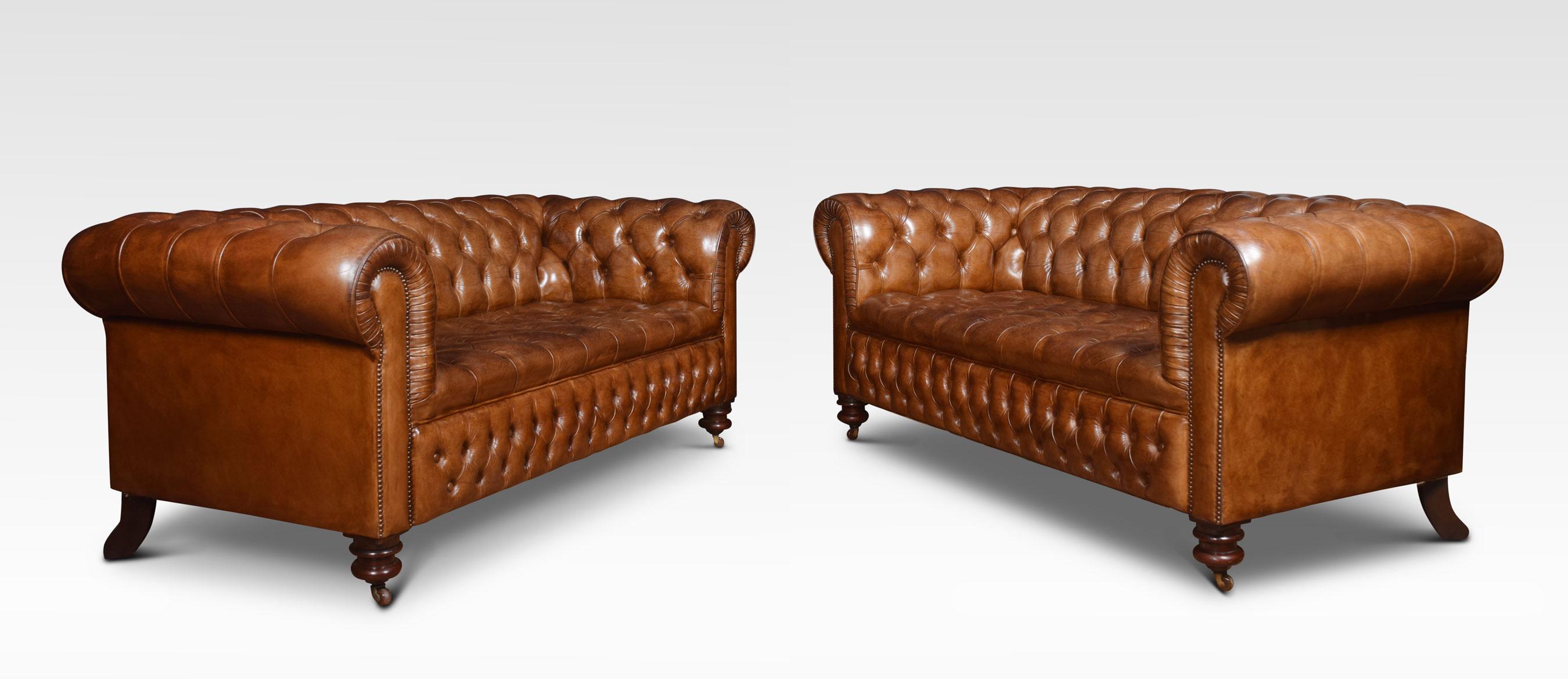 Pair of large three seater brown leather Chesterfield sofas, having deep buttoned back and seat, raised up on turned feet with brass ceramic castors. Good solid condition, the leather is soft, nicely worn in.
Dimensions:
Height 31 inches height to