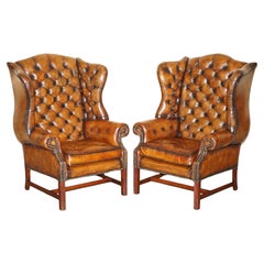 PAIR OF BROWN LEATHER THOMAS CHiPPENDALE CHESTERFIELD TUFTED WINGBACK ARMCHAIRS