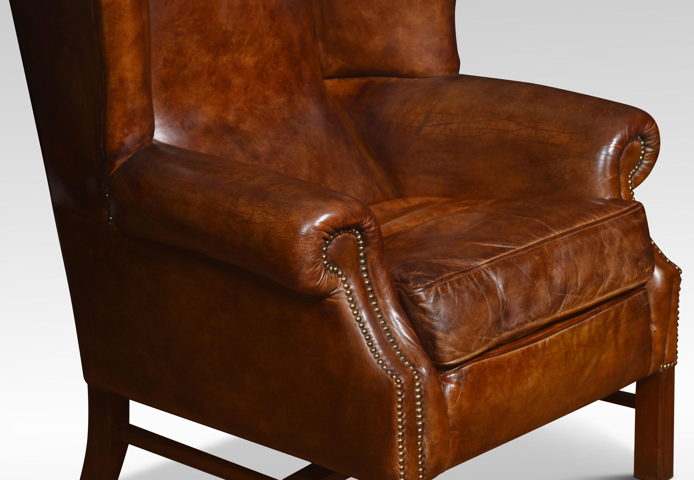 British Pair of brown leather upholstered wingback armchairs For Sale