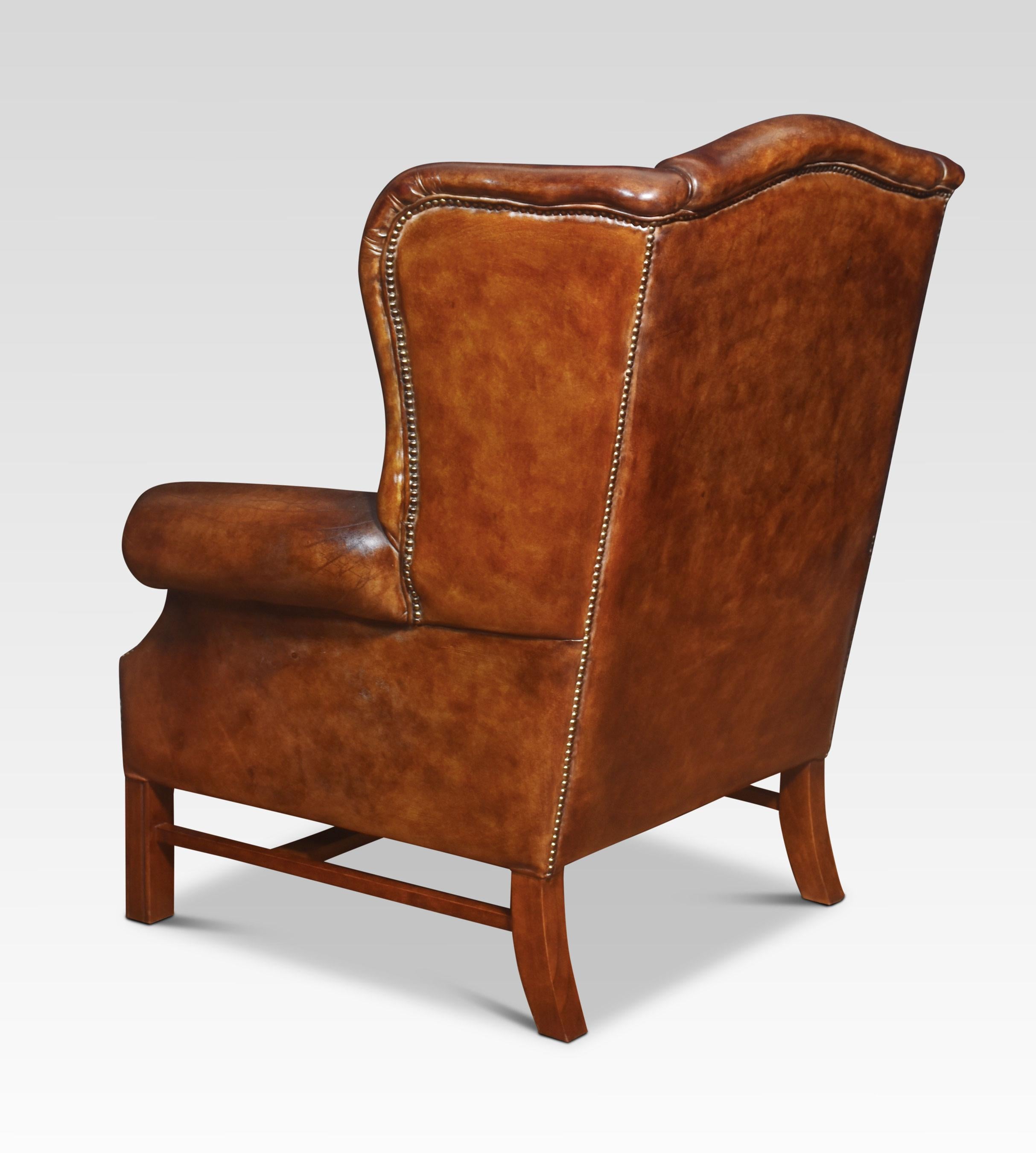 Leather Pair of brown leather upholstered wingback armchairs For Sale
