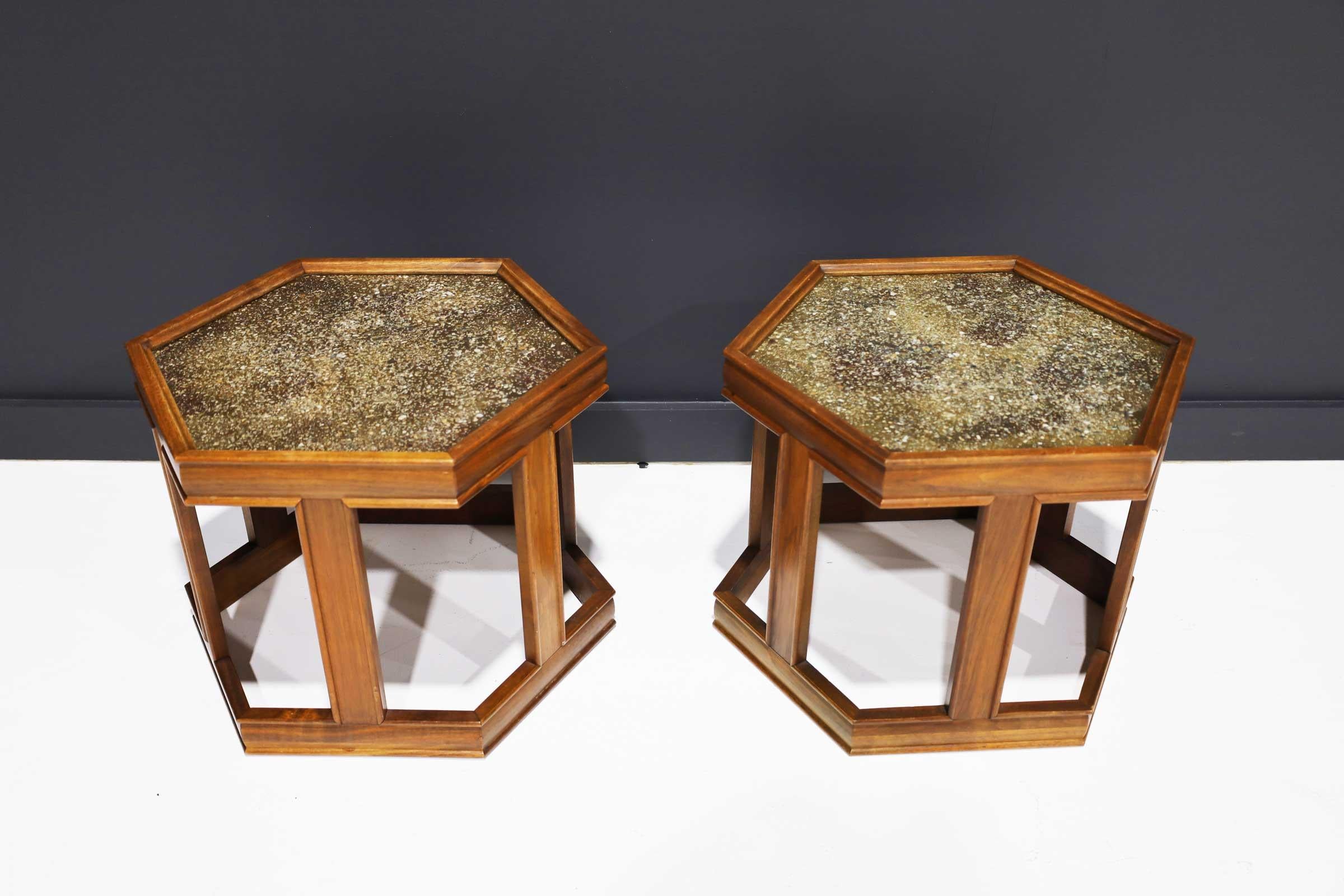 Pair of John Keal for Brown Saltman Hexagon Tables, walnut with inset pebble composite tops under glass, on squared legs joined at the base by stretchers.

Brown Saltman
Brown-Saltman was a collaboration between Dave Saltman and Paul Frankl, a