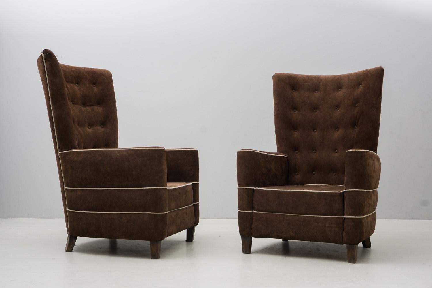 These rare armchairs by Guglielmo Ulrich have a solid and intimate feel. Covered with a brown suede, possibly reupholstered some time ago. Feet made of walnut.

Guglielmo Ulrich was born in Milan in 1904, the son of Albert and Luisa Battaglia. Of