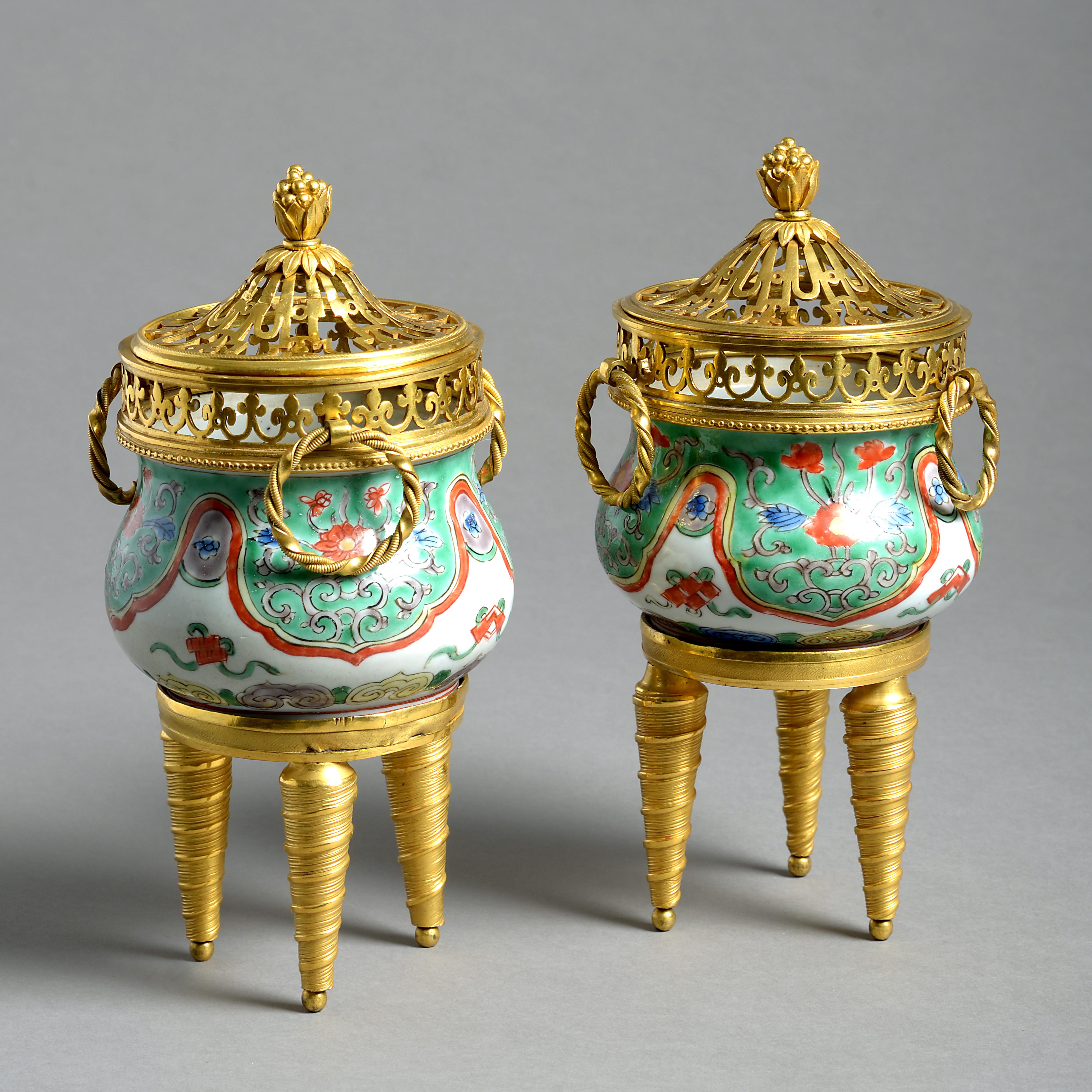 A fine pair of ormolu-mounted porcelain Brule parfums. The porcelain Kangxi, mounted in Paris, circa 1820.