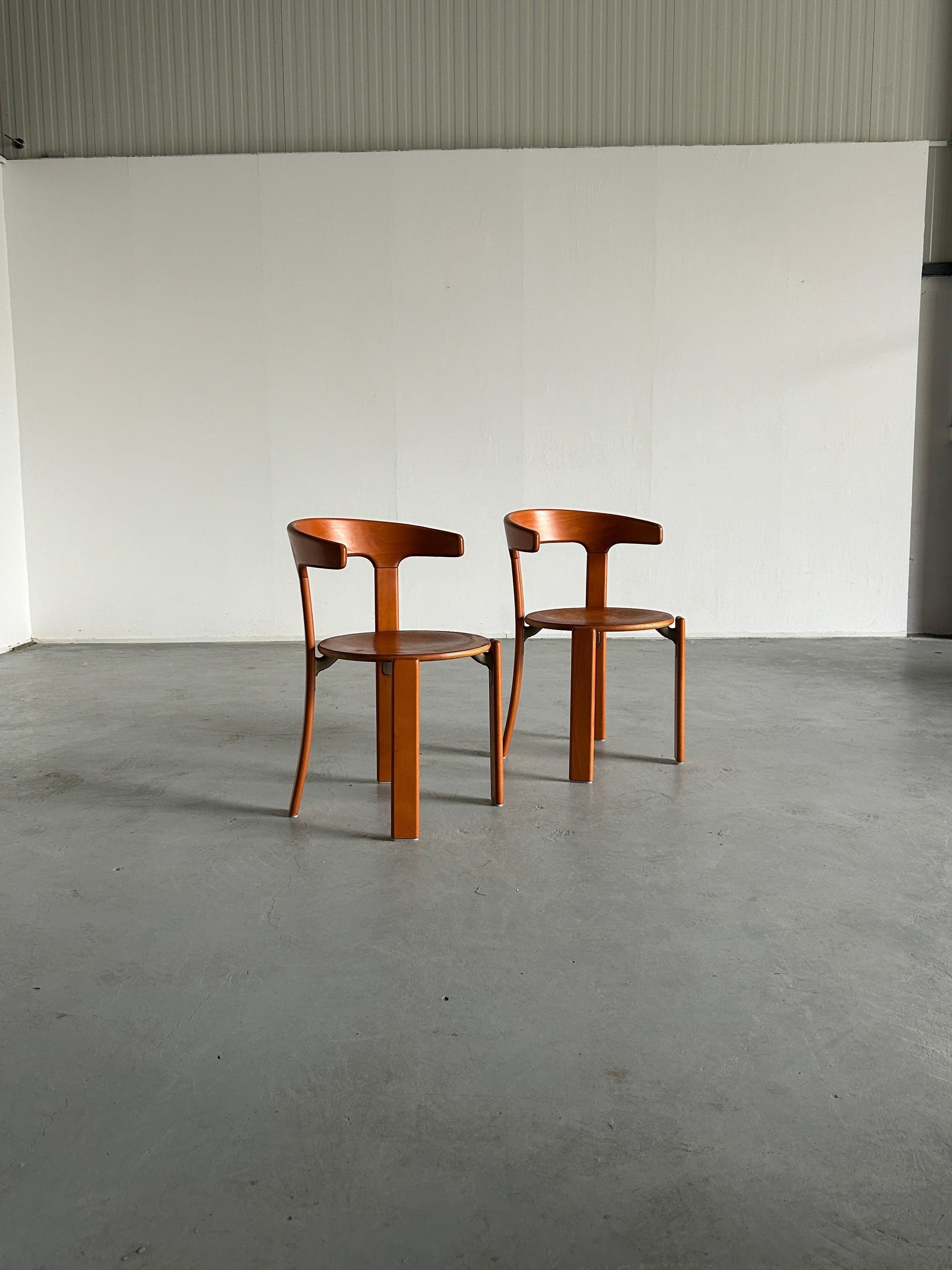 Pair Mid-Century-Modern dining chairs designed by Bruno Rey, 1970s. Model with the armrests.
Produced by Kusch+Co, 1994.

The dining chairs were made of solid beech, laminated plywood beech and cast aluminium. Characteristic steel brackets support