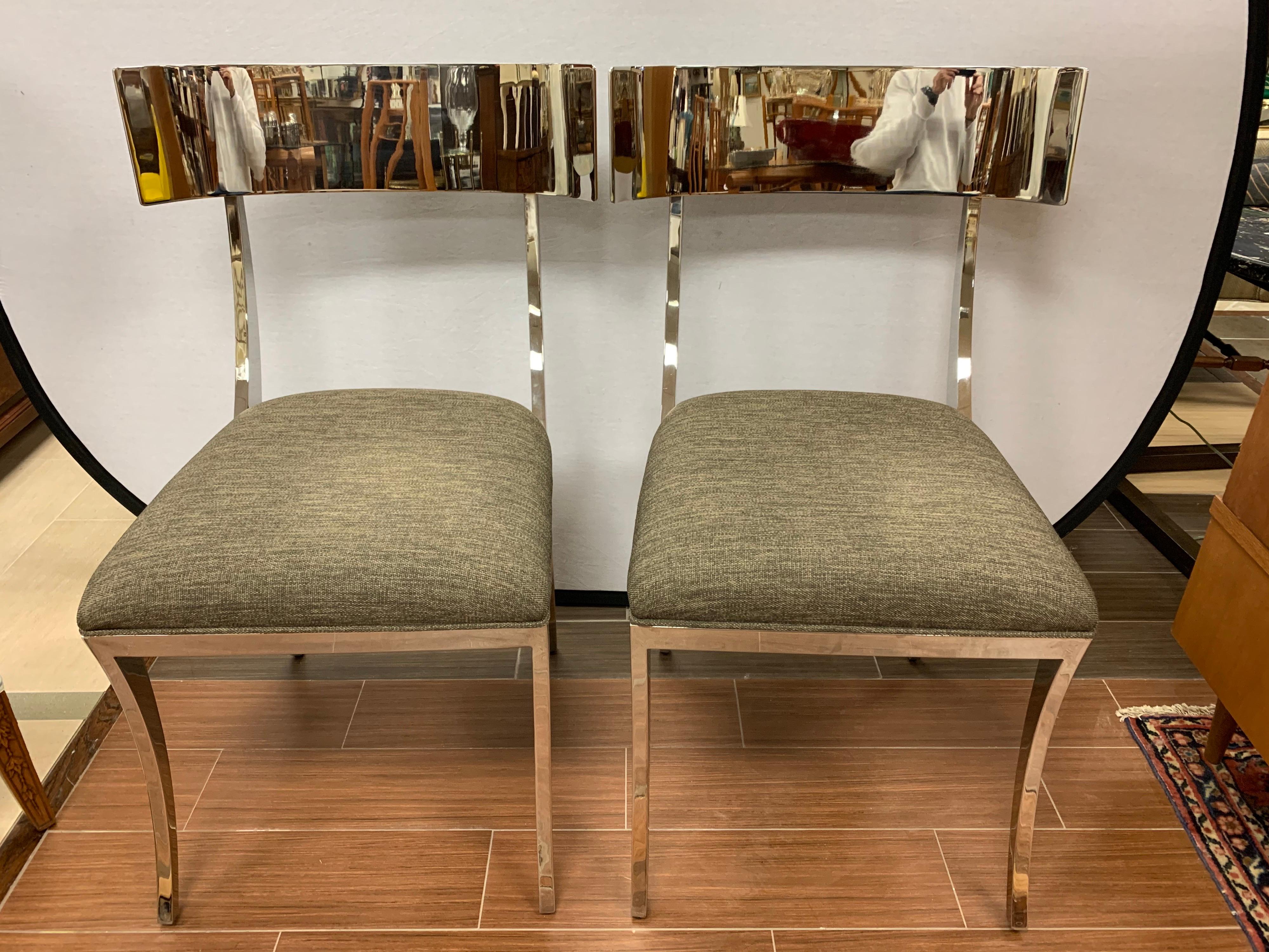 Elegant pair of polished chrome Klismos chairs, circa late 20th century, USA. Sleek neoclassical style polished chrome klismos chairs with upholstered dark gray linen seat. Sexy, beautiful curves and heavy, solid construction.