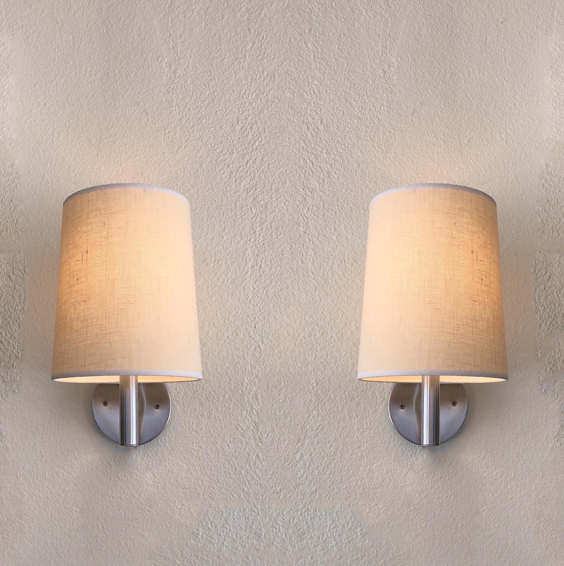 1970’s pair of brushed stainless steel wall sconces design by Walter Von Nessen for Nessen Studio. 
The stainless steel is n original condition, so it shows minor wear.
They have a full range dimmer and take a 75w max regular Edison