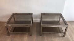 Pair of brushed steel side tables with smoked glass by Guy Lefèvre