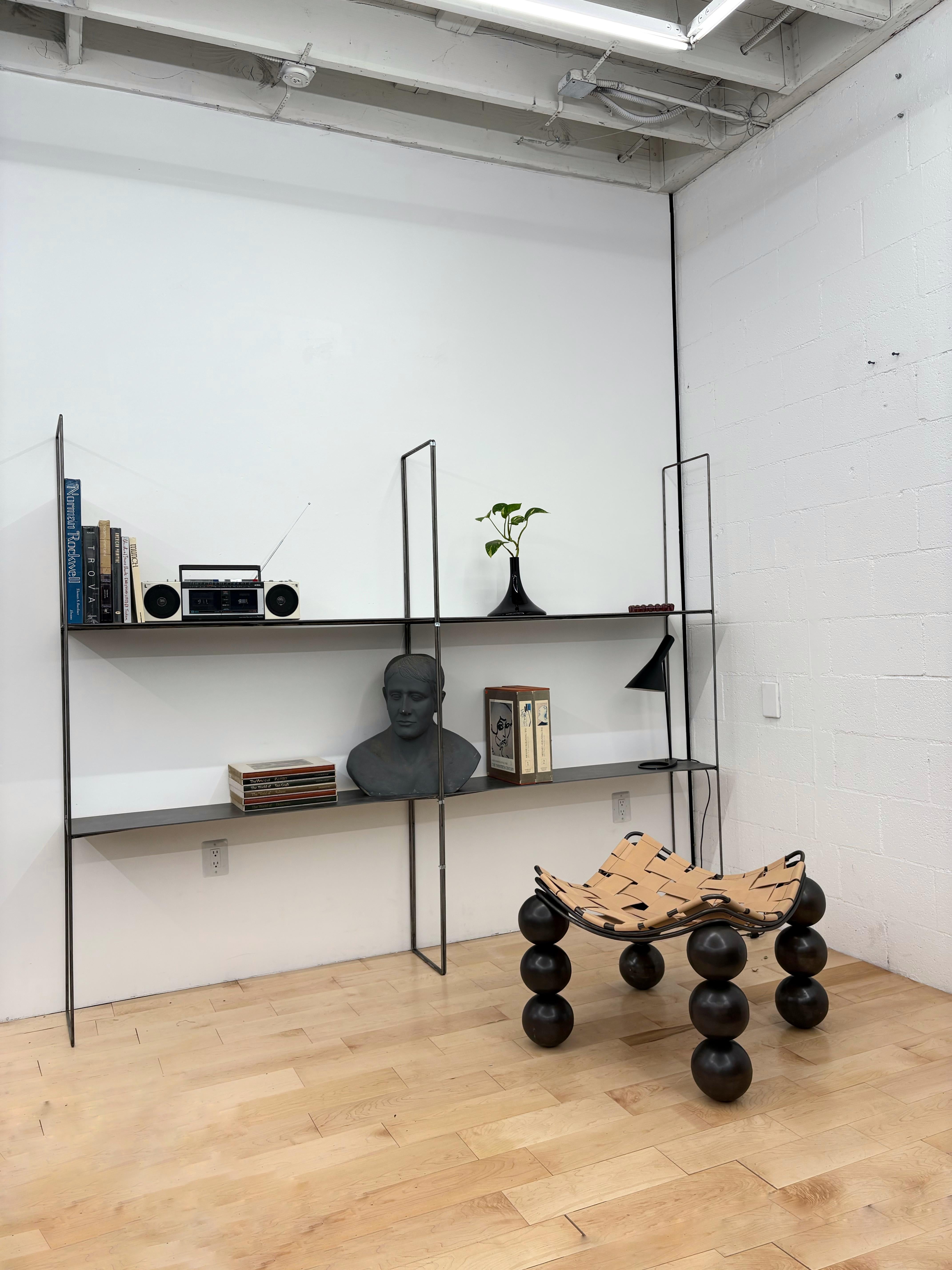 A pair of ultra-minimalist modular steel shelving units, (two pairs available) designed and handcrafted in Los Angeles by Dieppa Design for a contemporary art show. These architecturally inspired shelves feature a raw, industrial aesthetic, with