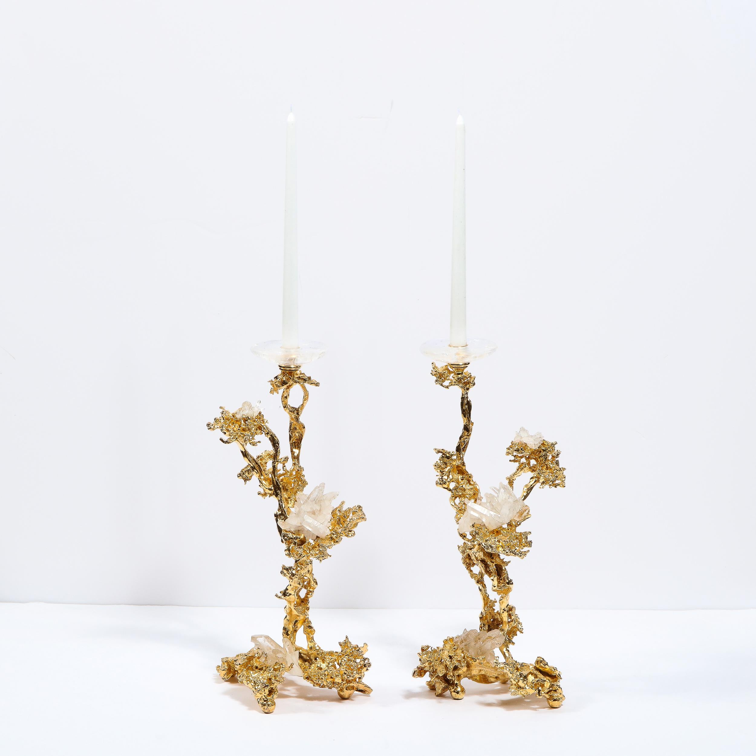 This dramatic and elegant pair of Mid-Century Modern candlesticks were realized in France by the esteemed artisan Claude Victor Boeltz. They offer an exploded form sculpted, by hand, and cast in bronze, consisting of a single arm and three feet