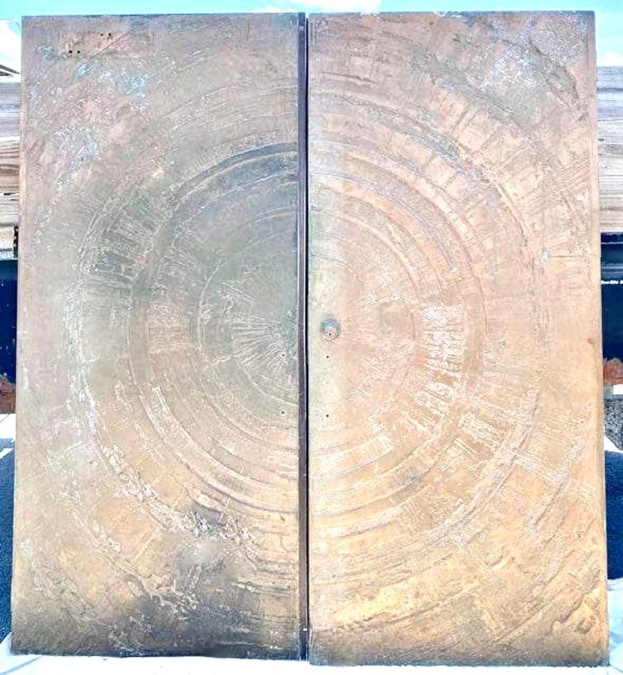Pair of Bronze Entry Doors... A Mid-Century Jewel and great statement piece for the front of any Mid-Century Style space.  

The pair were acquired from a Palm Beach Estate, and are a true piece of mid century architectural importance.  At 3' wide