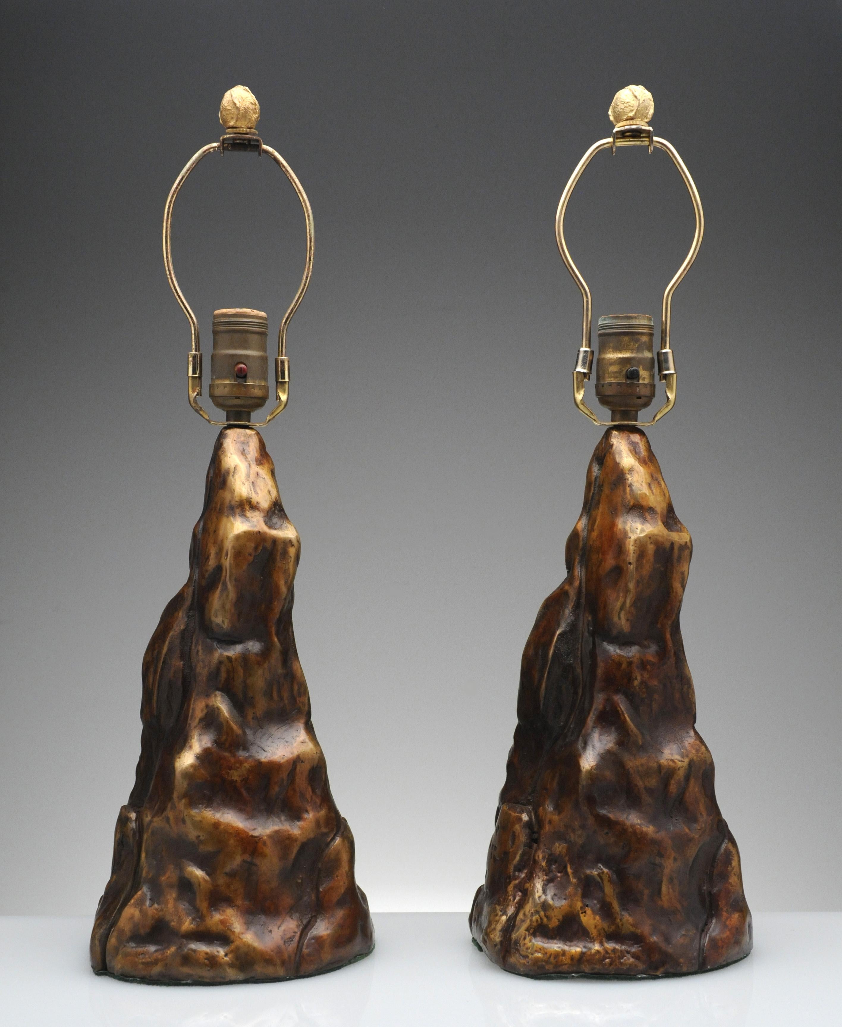 Exceptional vintage pair of bronze table lamps. Lamps retain the original bronze finial and have a beautiful warm brown patina.  These unique lamps are high quality made and heavy for their size. 