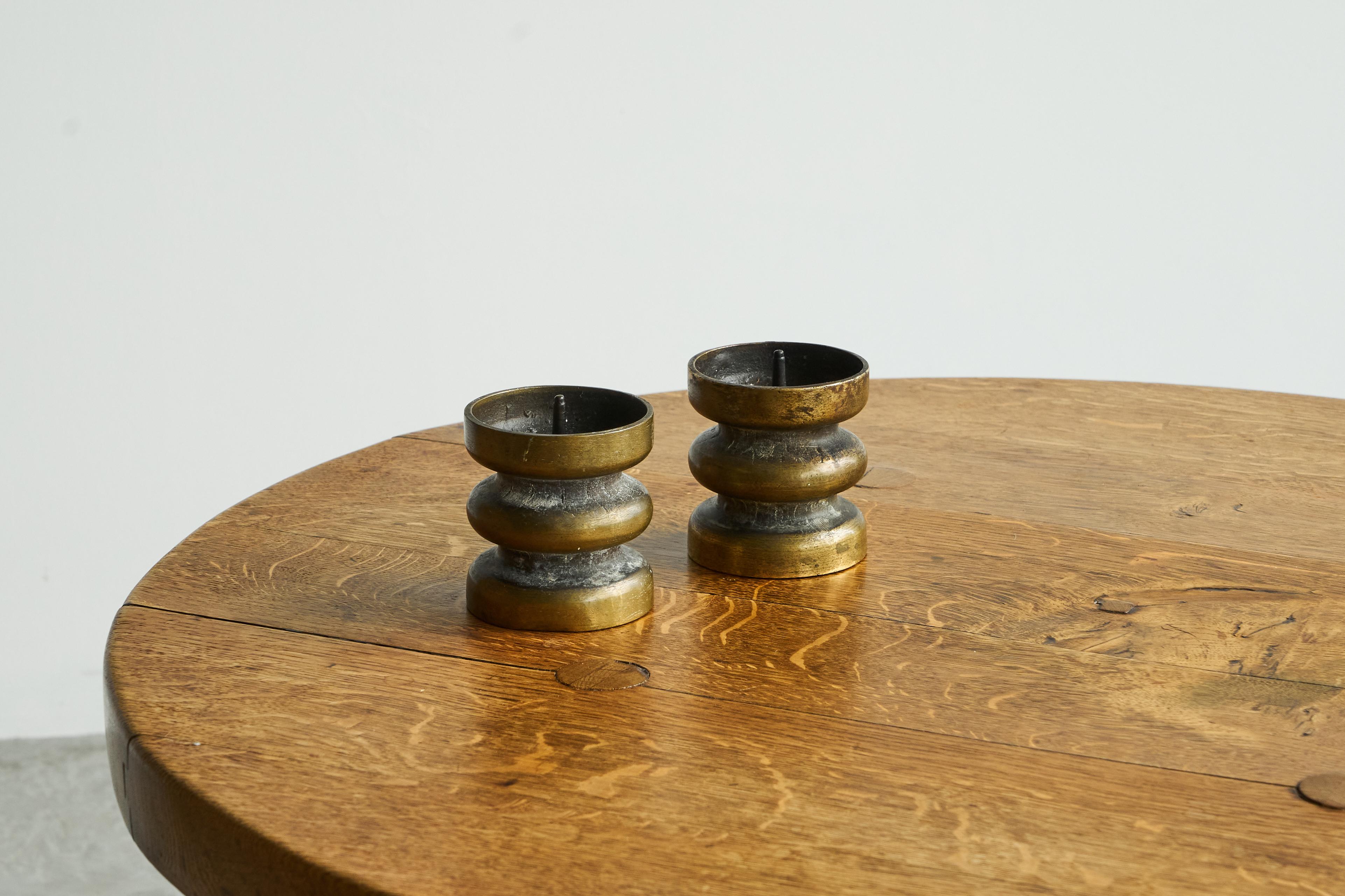Pair of Brutalist Candle Holders in Patinated Bronze 1960s.

Beautiful pair of brutalist style candle holders in patinated bronze. Heavy quality and execution, very nice brutalist design. Great patina, which gives these candle holders a very good